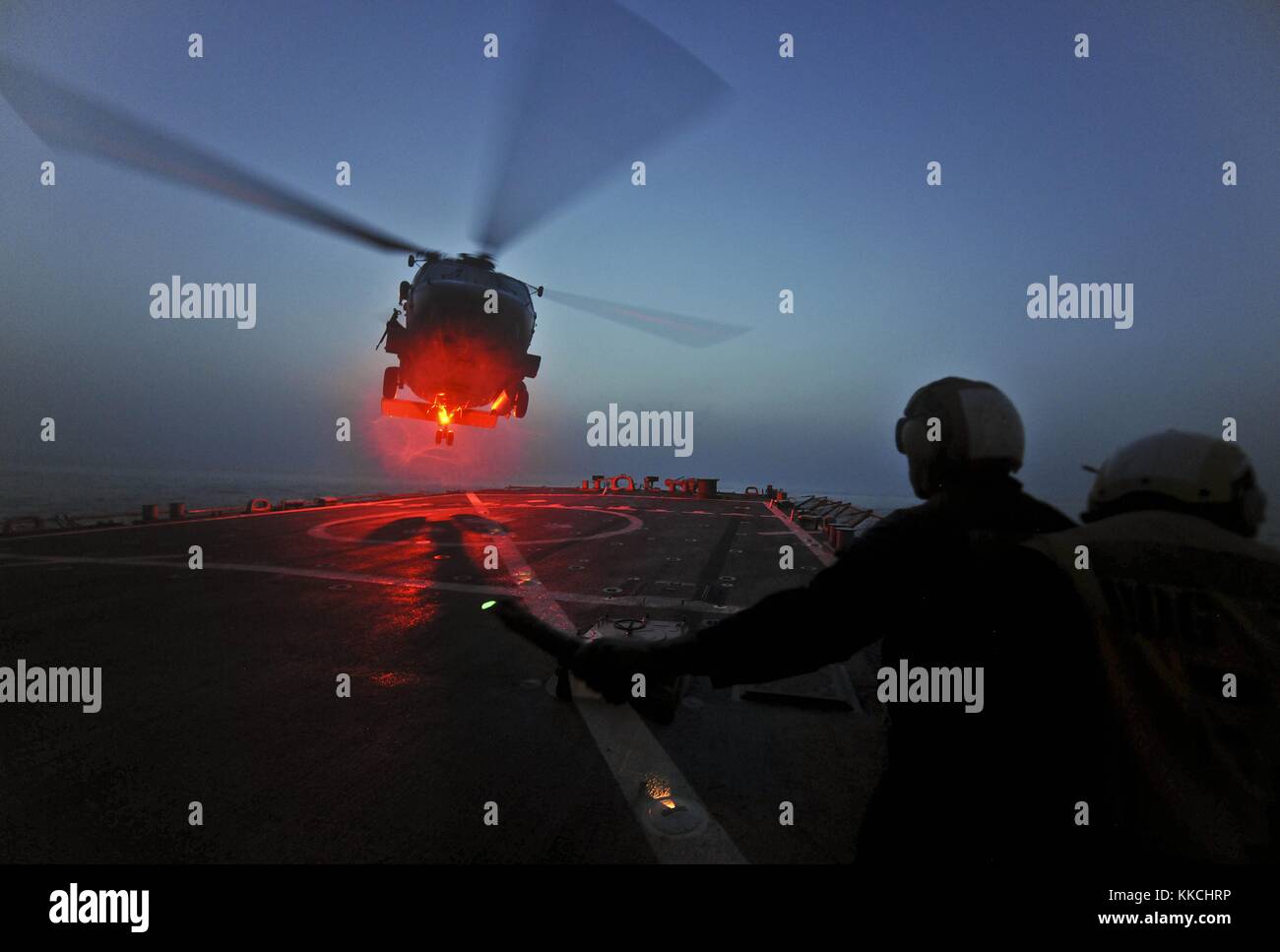 Boatswain's Mate 2nd Class Leon Simmons, assigned to the guided-missile destroyer USS Porter DDG 78, signals to an SH-60B Sea Hawk helicopter during deck-landing qualifications, 120519-N-Wo496-007 Arabian Gulf. Image courtesy U.S. Navy Photo by Mass Communication Specialist 3rd Class Alex R. Forster/US Navy. 2012. Stock Photo
