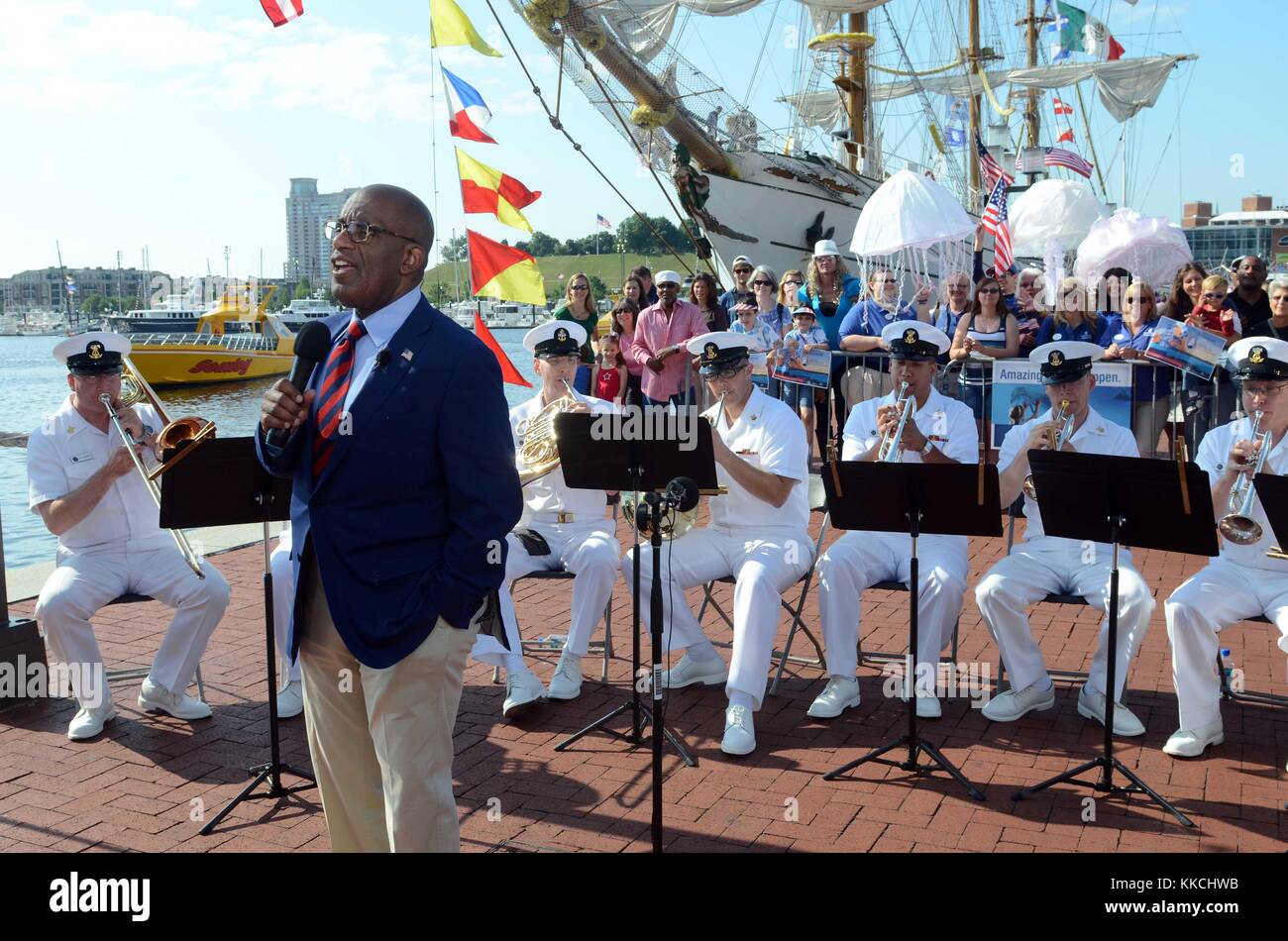 Members of the US Navy Ceremonial Band perform behind Al Roker during a