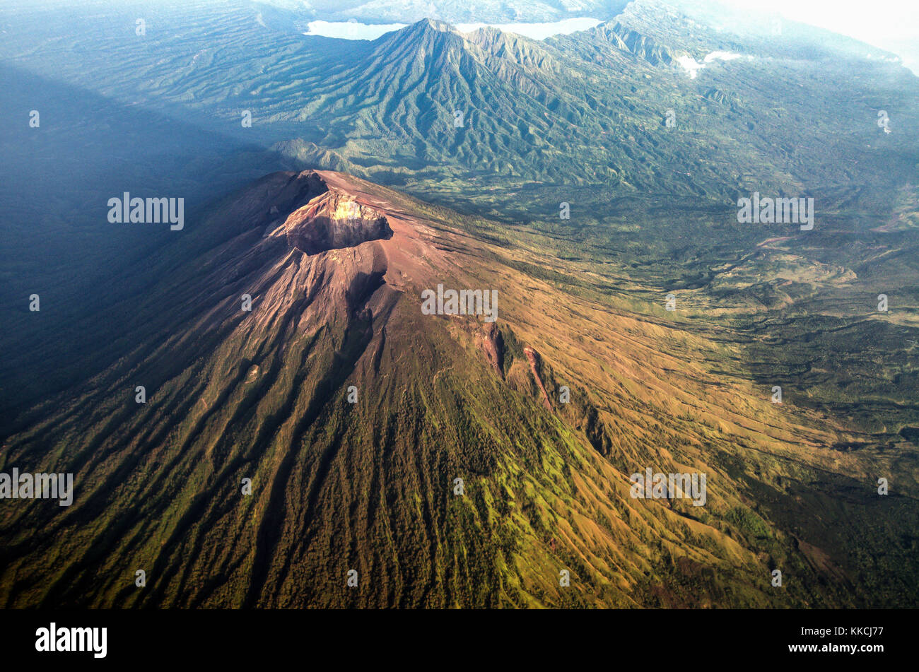 Mount Agung and its shadow from sunrise with mount Abang and mount Batur in the background. Stock Photo