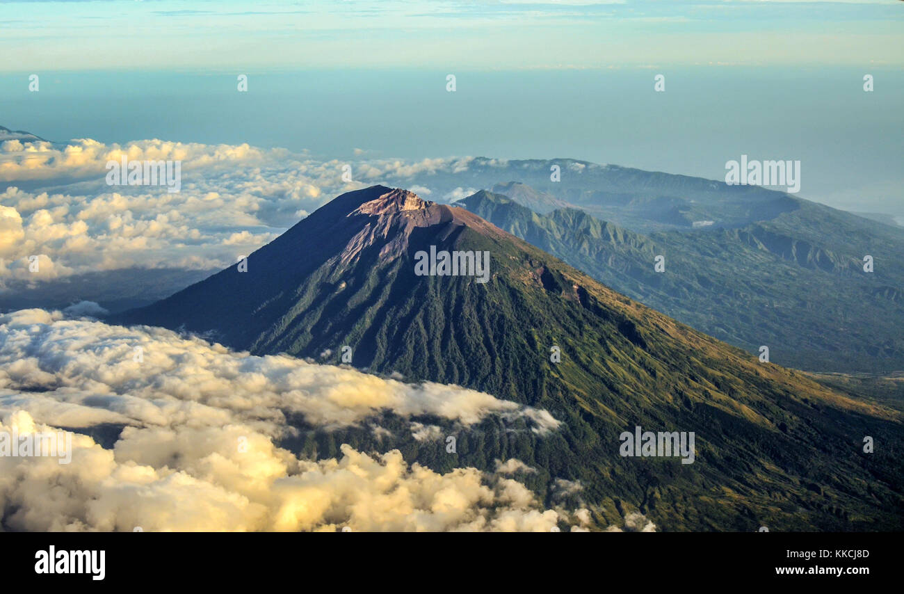 Mount Agung and the blanket of cloud with mount Abang and mount Batur in the Background. Stock Photo