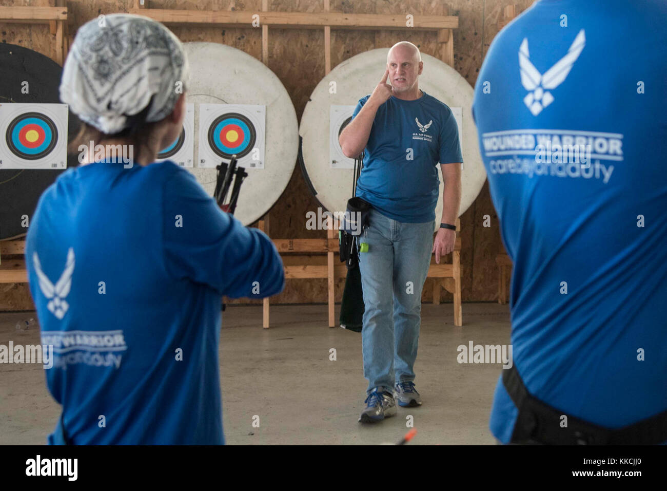 Jeff Matuszak, Warrior CARE coach, teaches wounded warriors how to shoot a bow and arrow during an archery training session as part of the Air Force Wounded Warrior CARE Event at Joint Base Andrews, Md., Nov. 13, 2017. This was one of multiple activities during the event that hosted various sports presentations and lessons for injured service members to introduce them to new outlets and prepare potential competitors for the 2018 Department of Defense Warrior Games and 2018 Invictus Games. (U.S. Air Force photo by Airman 1st Class Valentina Lopez) Stock Photo