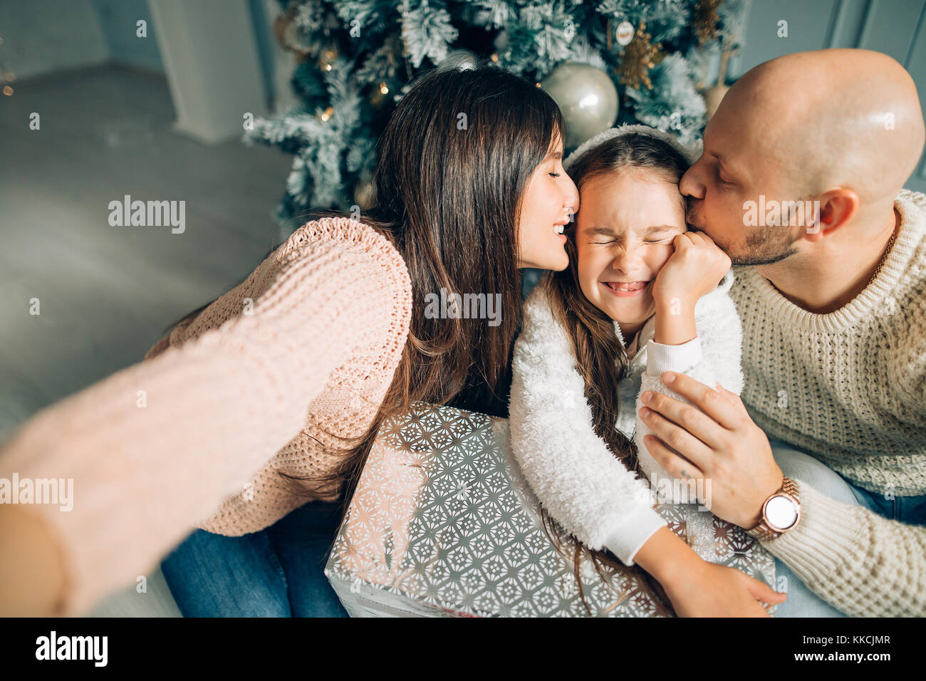 Cheerful family making comic xmas selfie and showing tongues Stock Photo