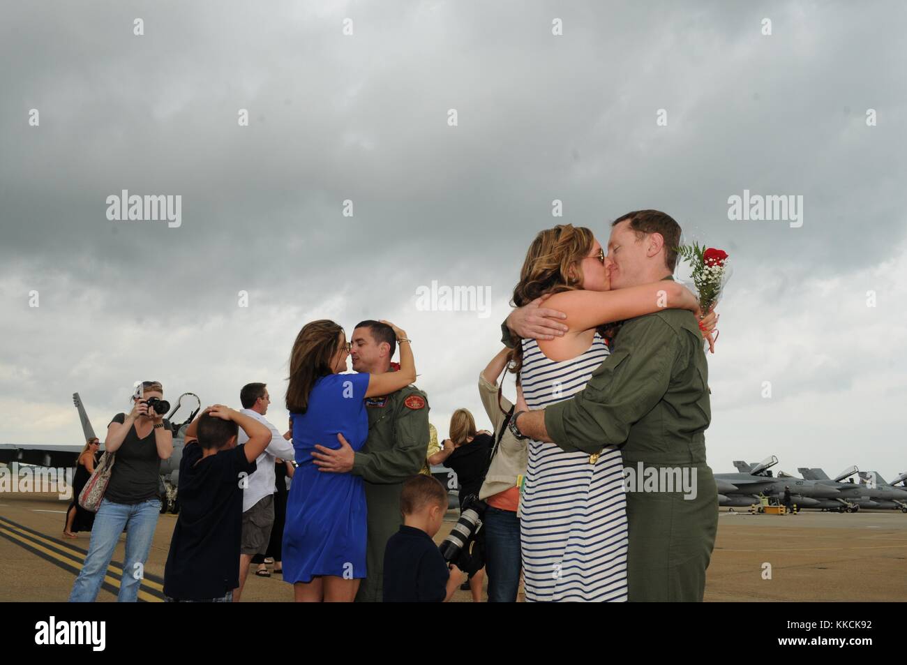 Commander Richard Rivera, left, and Lt Ben Horn, both assigned to the Sunliners of Strike Fighter Squadron VFA 81, are reunited with their families after returning home from a six-month deployment, Virginia Beach, Va. Image courtesy Mass Communication Specialist 3rd Class Antonio P. Turretto Ramos/US Navy, 2012. Stock Photo