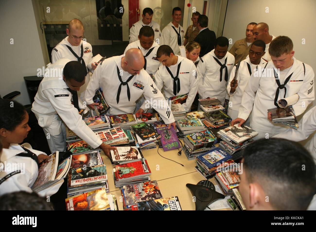 Sailors and Marines look through comic books during a tour of the DC Comics facility during Fleet Week New York 2012, New York. Image courtesy Mass Communication Specialist 1st Class David P. Coleman/US Navy, 2012. Stock Photo