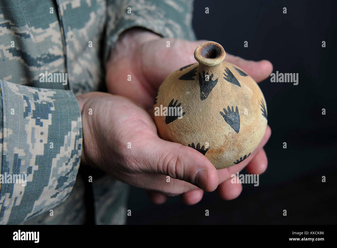 Capt. Travis Trueblood, 11th Wing assistant staff judge advocate, holds a piece of pottery at Joint Base Andrews, Md., Nov. 16, 2017. The pottery was gifted to Trueblood by a member of the Choctaw and Seminole Nations during a speech he gave about federal American Indian law at a the University of Florida for the 2016 National American Indian Heritage Month. (U.S. Air Force photo by Airman Michael Murphy) Stock Photo