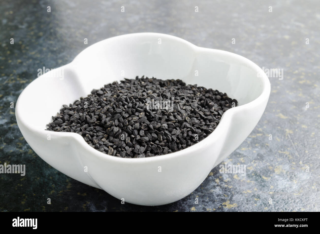 Black Onion Seeds (Nigella Sativa) in a White Bowl Stock Photo