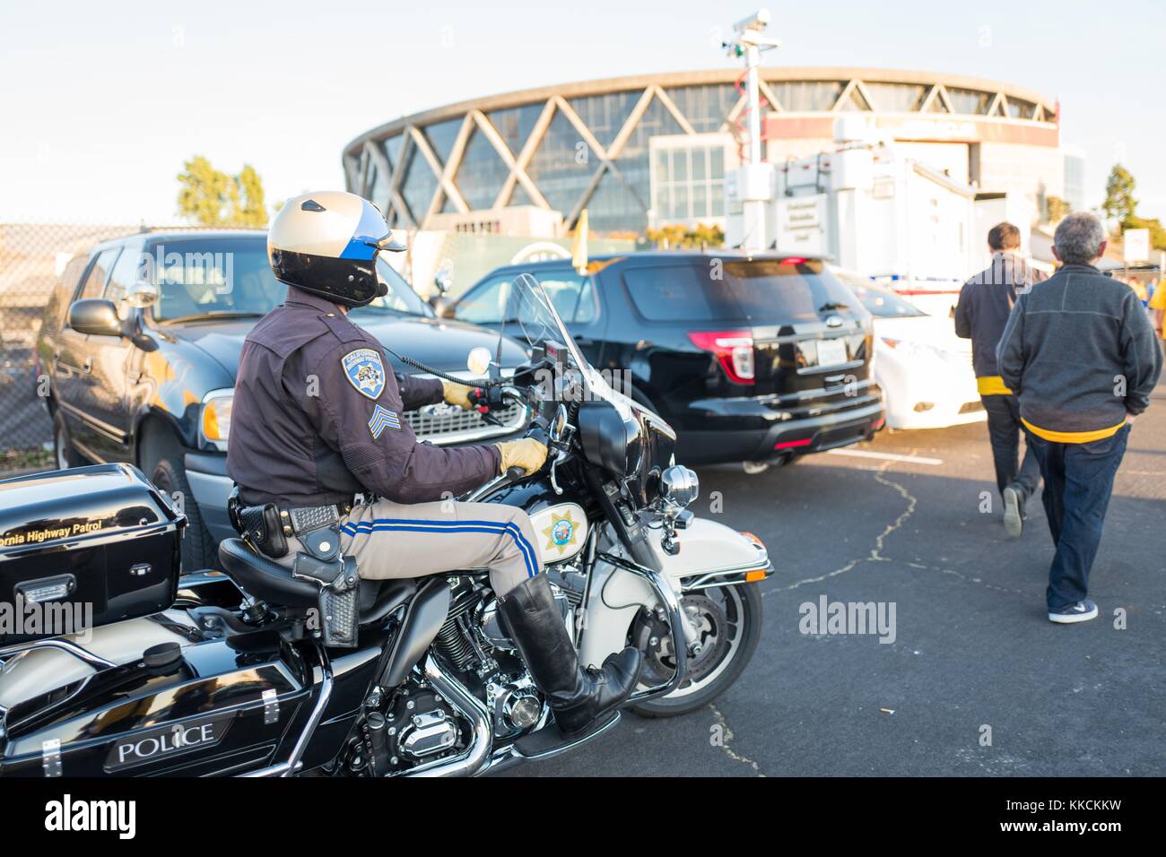 Outside Oracle Arena, an Oakland Police Department motorcycle police officer patrols the crowd following a Golden State Warriors basketball game, Oakland, California, June 5, 2016. Stock Photo