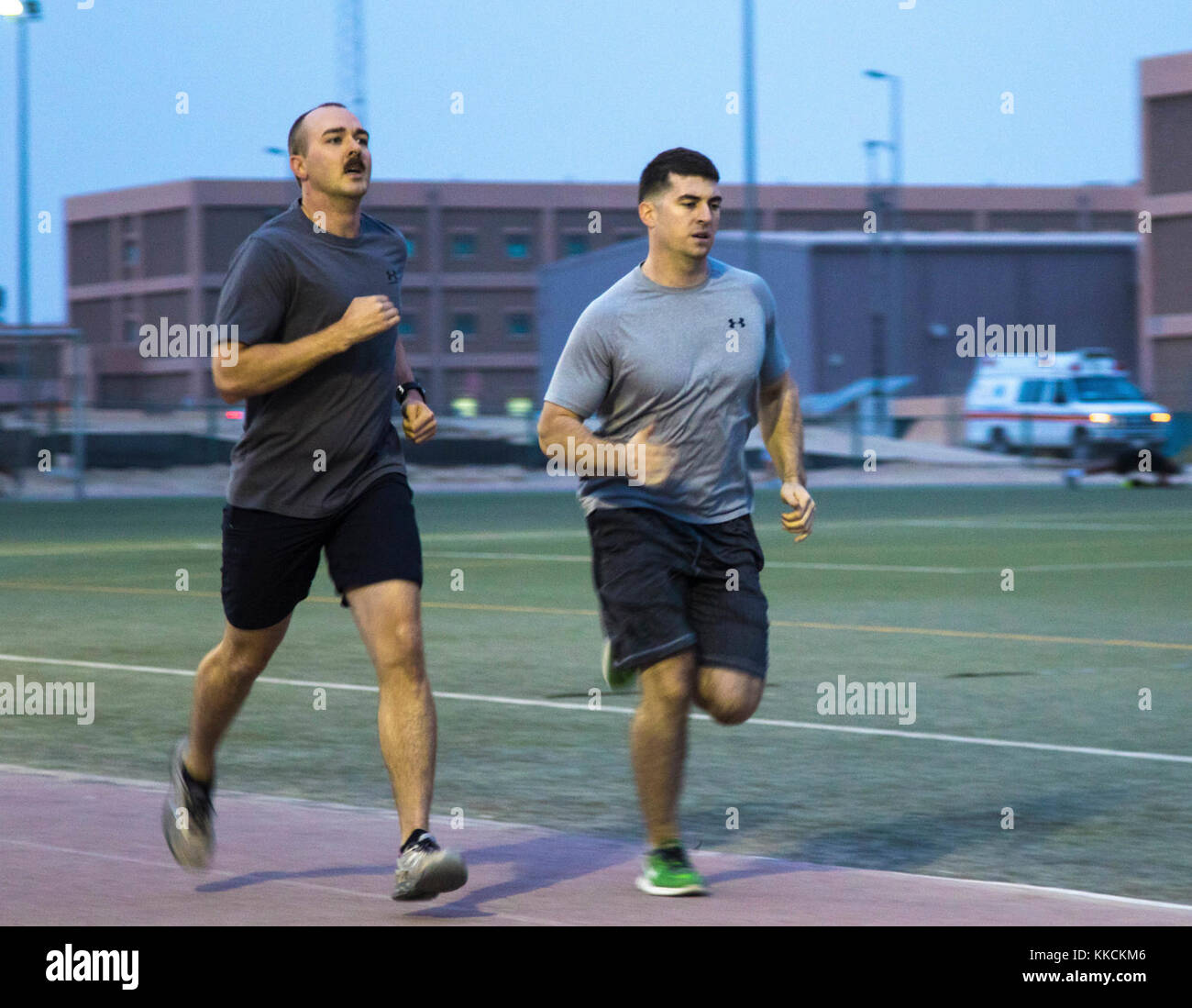 CAMP ARIFJAN, Kuwait (Nov. 24, 2017) - 1st Lt. Travis Krimmel, HHC XO for the 135th ESC, gains footing against another contestant during the 1000 meter dash. The dash hang was a part of the second event for the German Armed Forces Proficiency Badge. Participants had to complete a shuttle run, 1000 meter dash and a flexed arm hang back to back in order to continue to the next event. The #GAFPB was hosted by the 1st Theater Sustainment Command - OCP, the next events are the ruck march and the pistol range. (U.S. Army photos by Sgt. Jaccob Hearn) Stock Photo