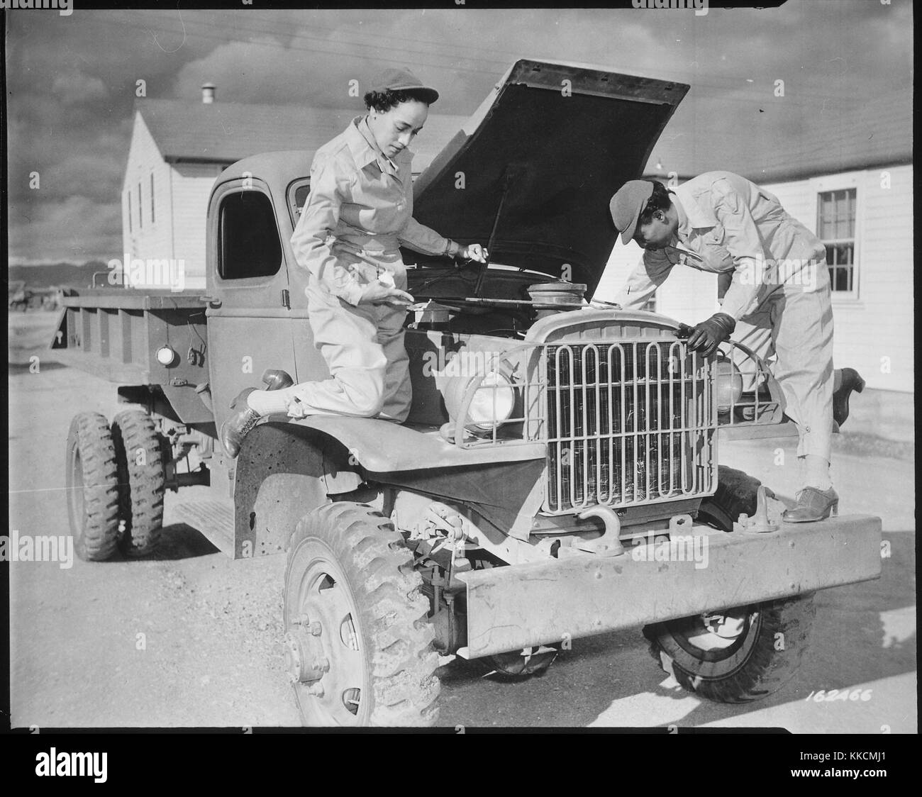 Female auxiliaries Ruth Wade and Lucille Mayo (left to right) further demonstrate their ability to service trucks as taught them during the processing period at Fort Des Moines and put into practice at Fort Huachuca, Arizona, during World War 2. Image courtesy National Archives. 1942. Stock Photo