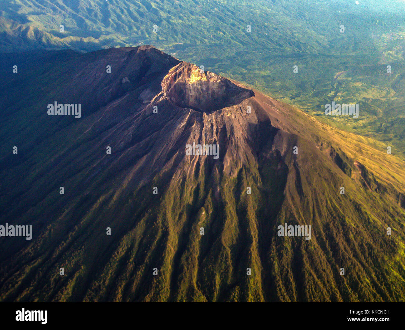 The crater of mount Agung as seen from airplane window with mount Abang and mount Batur in the background. Stock Photo