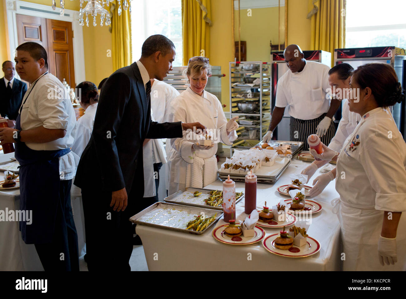 President Barack Obama samples a baked zucchini fry in the Old Family Dining Room of the White House after dropping by the East Room for the Kids' State Dinner, Aug. 20, 2012. (Official White House Photo by Pete Souza)  This official White House photograph is being made available only for publication by news organizations and/or for personal use printing by the subject(s) of the photograph. The photograph may not be manipulated in any way and may not be used in commercial or political materials, advertisements, emails, products, promotions that in any way suggests approval or endorsement of th Stock Photo