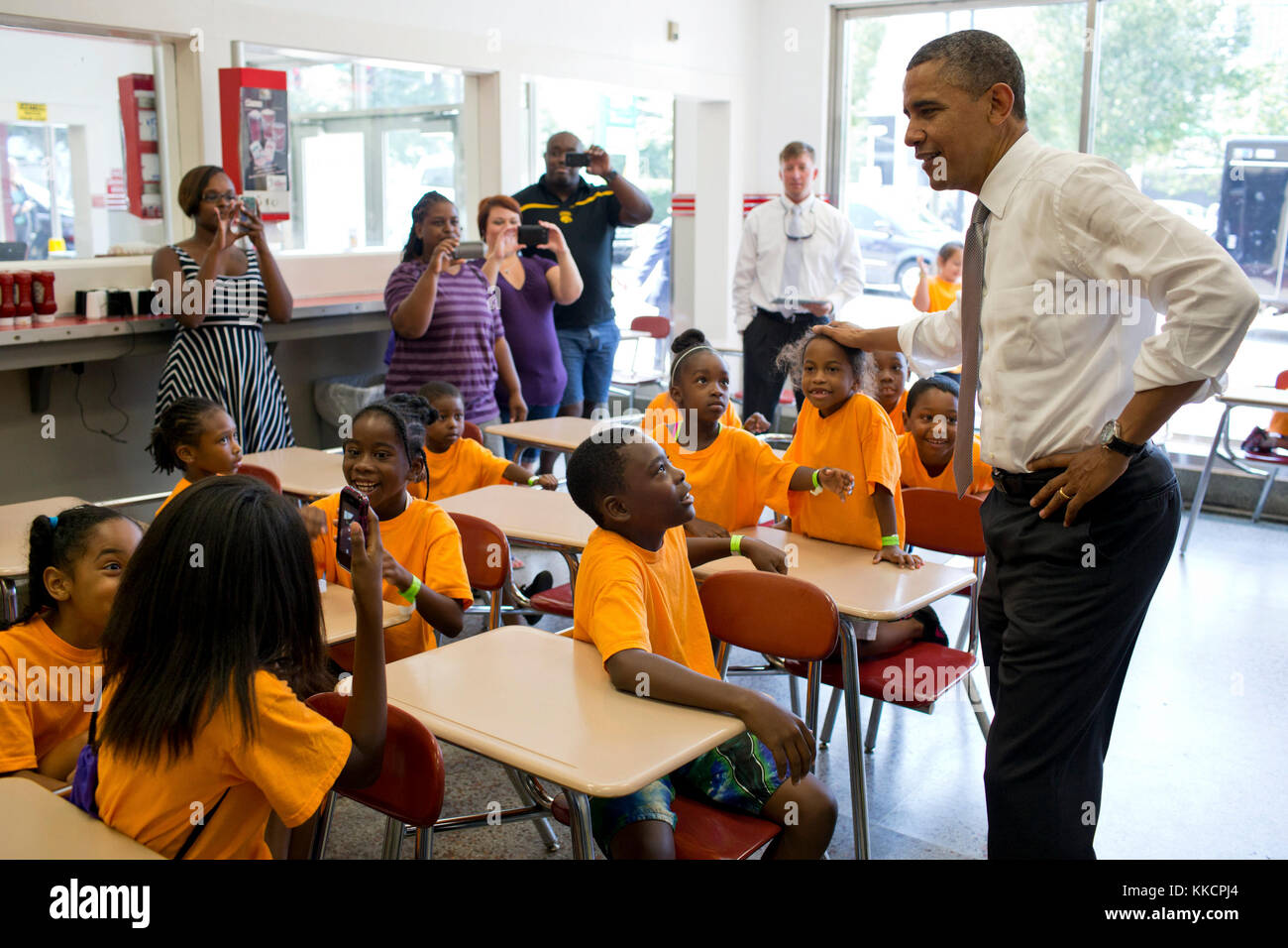 President Barack Obama talks to a group of kids from Lenora Academy in Snellville, Ga., during a stop at the Varsity, a restaurant in Atlanta, Ga., June 26, 2012. (Official White House Photo by Pete Souza)  This official White House photograph is being made available only for publication by news organizations and/or for personal use printing by the subject(s) of the photograph. The photograph may not be manipulated in any way and may not be used in commercial or political materials, advertisements, emails, products, promotions that in any way suggests approval or endorsement of the President,  Stock Photo