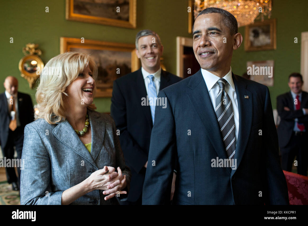 President Barack Obama waits with 2012 National Teacher of the Year, Rebecca Mieliwocki, 7th-grade English teacher at Luther Burbank High School, Burbank, Calif., and Education Secretary Arne Duncan in the Green Room of the White House before the start of a ceremony to honor the 2012 National and State Teachers of the Year in the East Room, April 24, 2012. (Official White House Photo by Pete Souza)  This official White House photograph is being made available only for publication by news organizations and/or for personal use printing by the subject(s) of the photograph. The photograph may not  Stock Photo