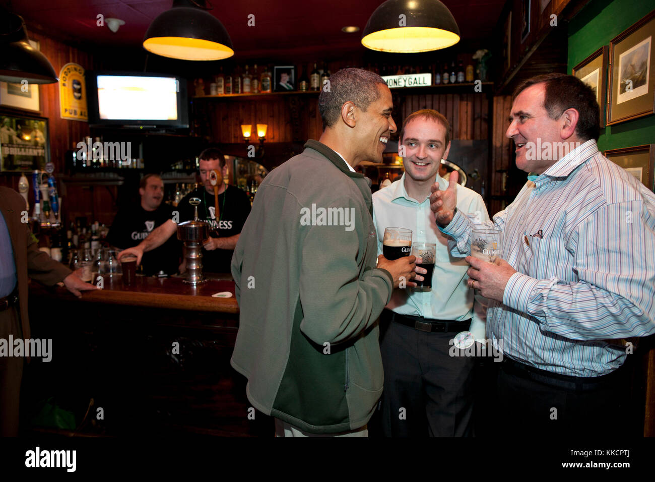 President Barack Obama visits the Dubliner, an Irish pub in Washington, D.C., with his Irish cousin, Henry Healy, center, and Ollie Hayes, a pub owner in Moneygall, Ireland, right, on St. Patrick's Day, Saturday, March 17, 2012. Stock Photo