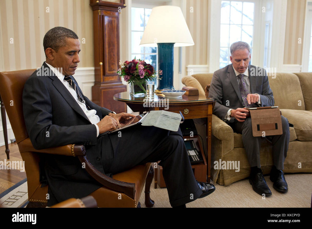 President Barack Obama receives the Presidential Daily Briefing from Robert Cardillo, Deputy Director of National Intelligence for Intelligence Integration, in the Oval Office, Jan. 31, 2012. Part of the briefing was done using a tablet computer. Stock Photo