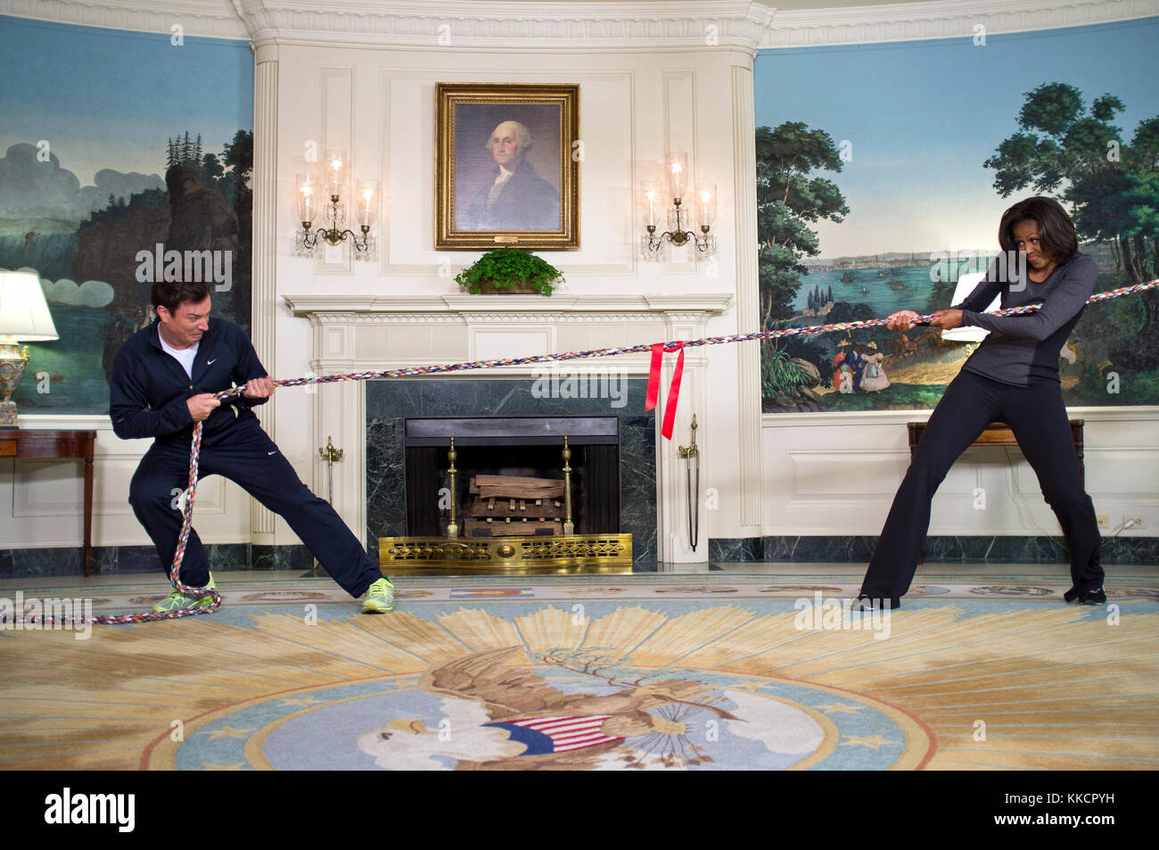 First Lady Michelle Obama participates in a tug of war with Jimmy Fallon in the Diplomatic Reception Room of the White House during a “Late Night with Jimmy Fallon” taping for the second anniversary of the 'Let’s Move!' initiative, Jan. 25, 2012. Stock Photo