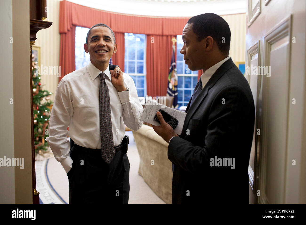 President Barack Obama talks with Rob Nabors, Assistant to the President for Legislative Affairs, in the Oval Office, Dec. 22, 2011. Nabors informed President Obama that a bipartisan agreement was reached to extend the payroll tax cut. Stock Photo