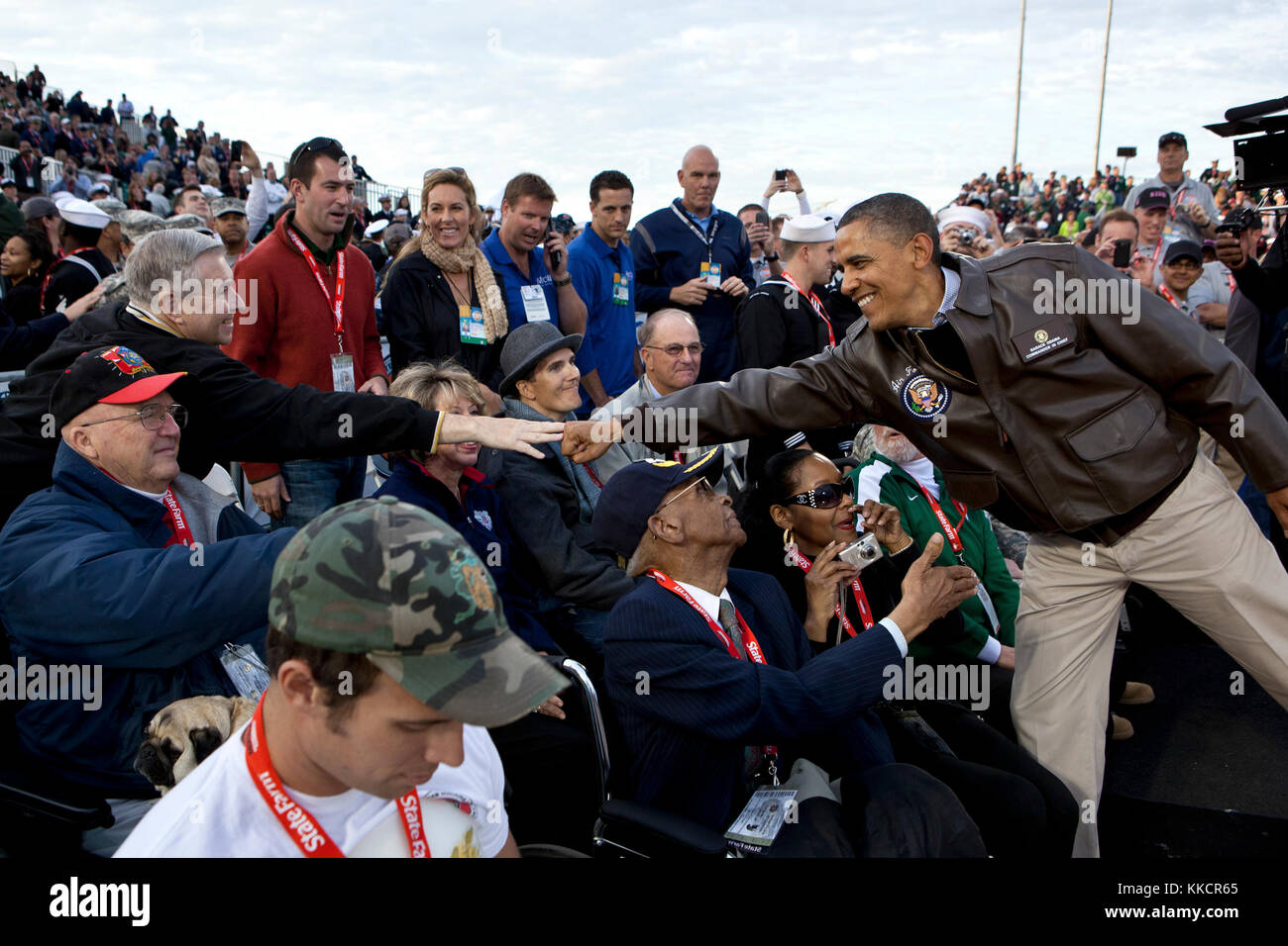 President Barack Obama greets veterans before the Carrier Classic basketball game between the University of North Carolina Tar Heels and Michigan State Spartans on the flight deck of the USS Carl Vinson, docked at North Island Naval Station in San Diego, Calif., Nov. 11, 2011. Stock Photo