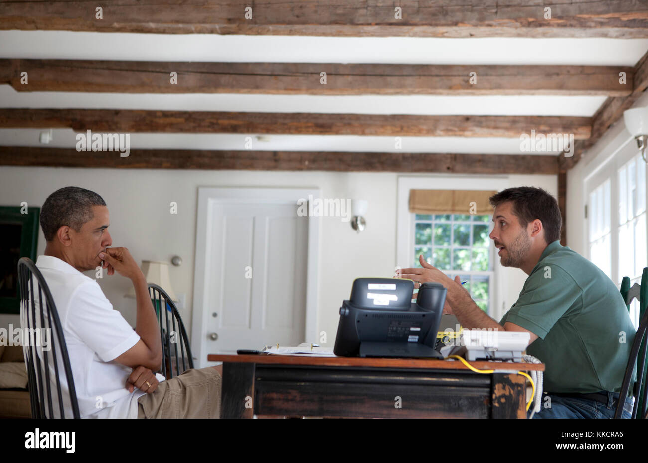 President Barack Obama receives an economic briefing from Brian Deese, Deputy Director of the National Economic Council, at the Fisher House at Blue Heron Farm in Chilmark, Massachusetts, August 24, 2011. Stock Photo