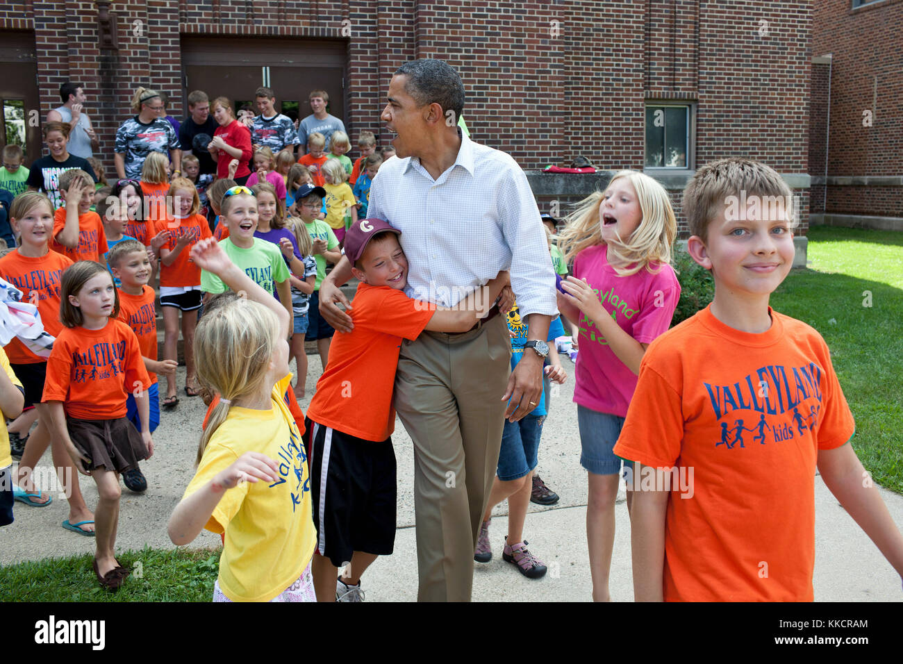 President Barack Obama greets children from the Valleyland Kids summer program outside a school in Chatfield, Minn., during a three-day bus tour in the Midwest, Aug. 15, 2011. Stock Photo