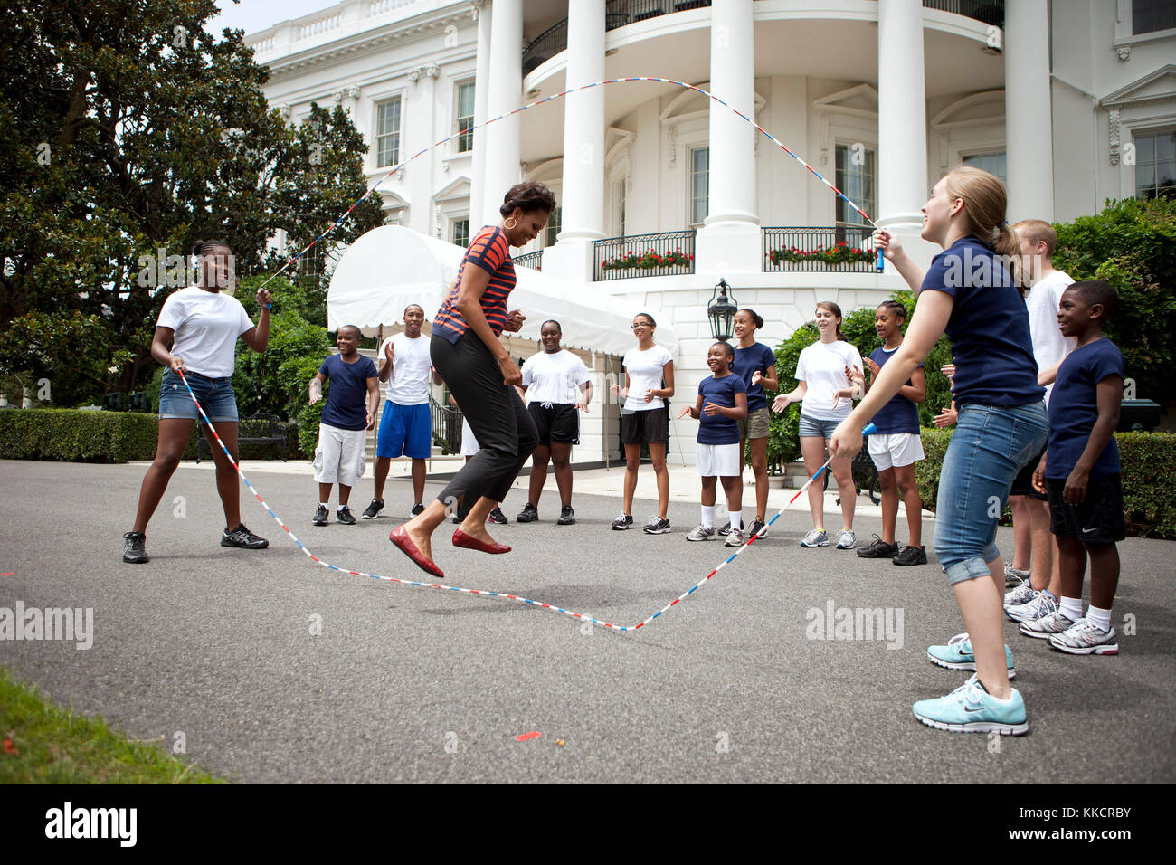 First Lady Michelle Obama and kids double-dutch jump rope during a taping for the Presidential Active Lifestyle Award (PALA) challenge and Nickelodeon's Worldwide Day of Play, on the South Lawn of the White House, July 15, 2011. Stock Photo