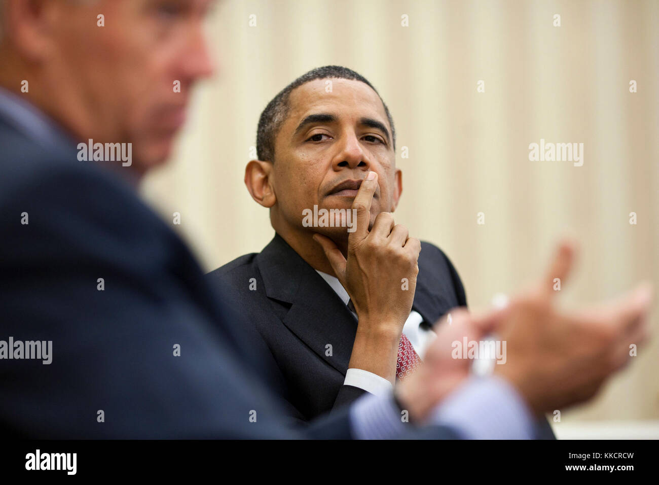 President Barack Obama listens as Vice President Joe Biden makes a point during a meeting with the Democratic leadership in the Oval Office, June 23, 2011. Stock Photo