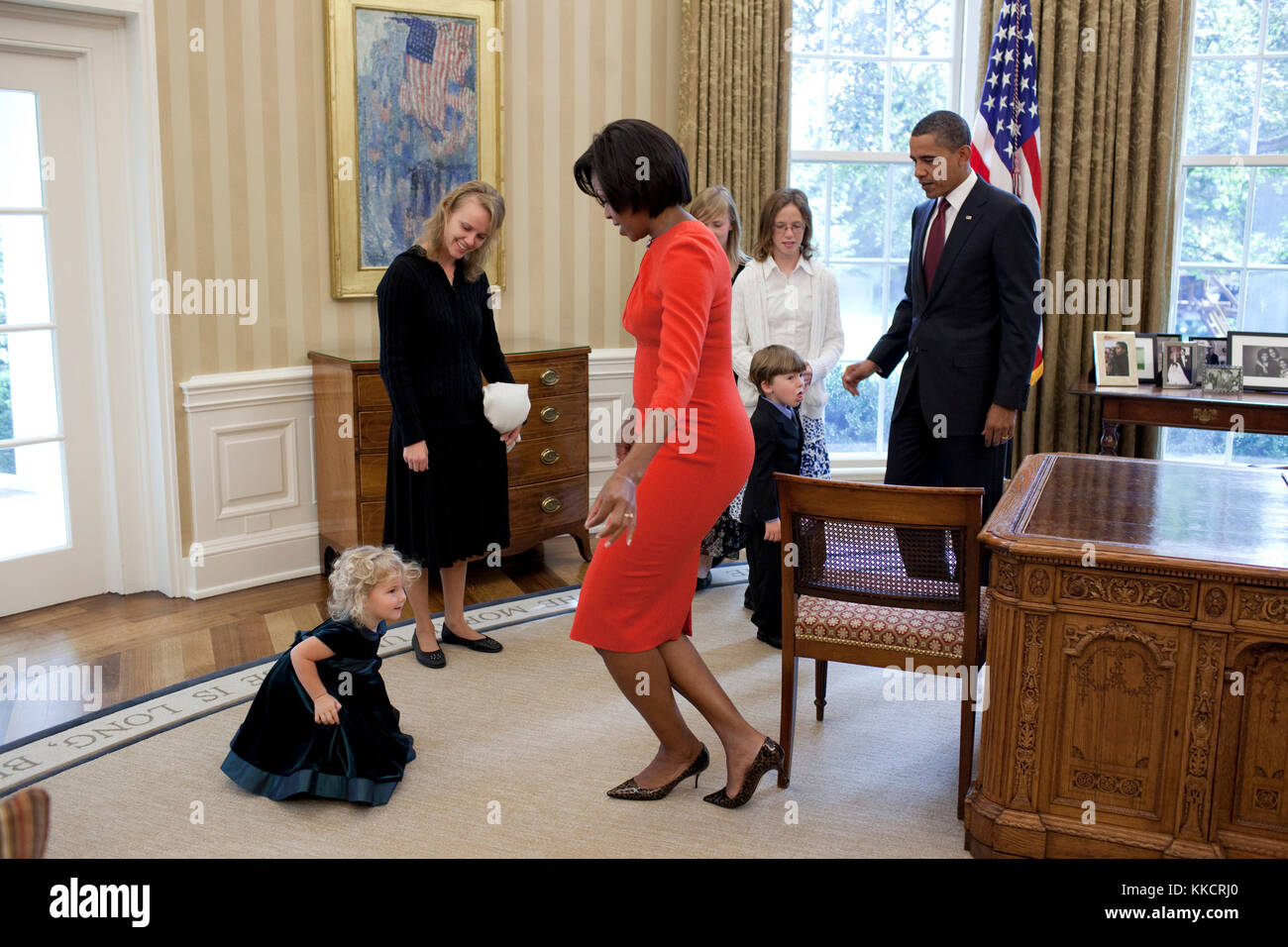 Oct. 6, 2010 'The First Lady curtsies with Lynne Silosky, a niece of posthumous Medal of Honor awardee, Staff Sergeant Robert J. Miller in the Oval Office.' Stock Photo