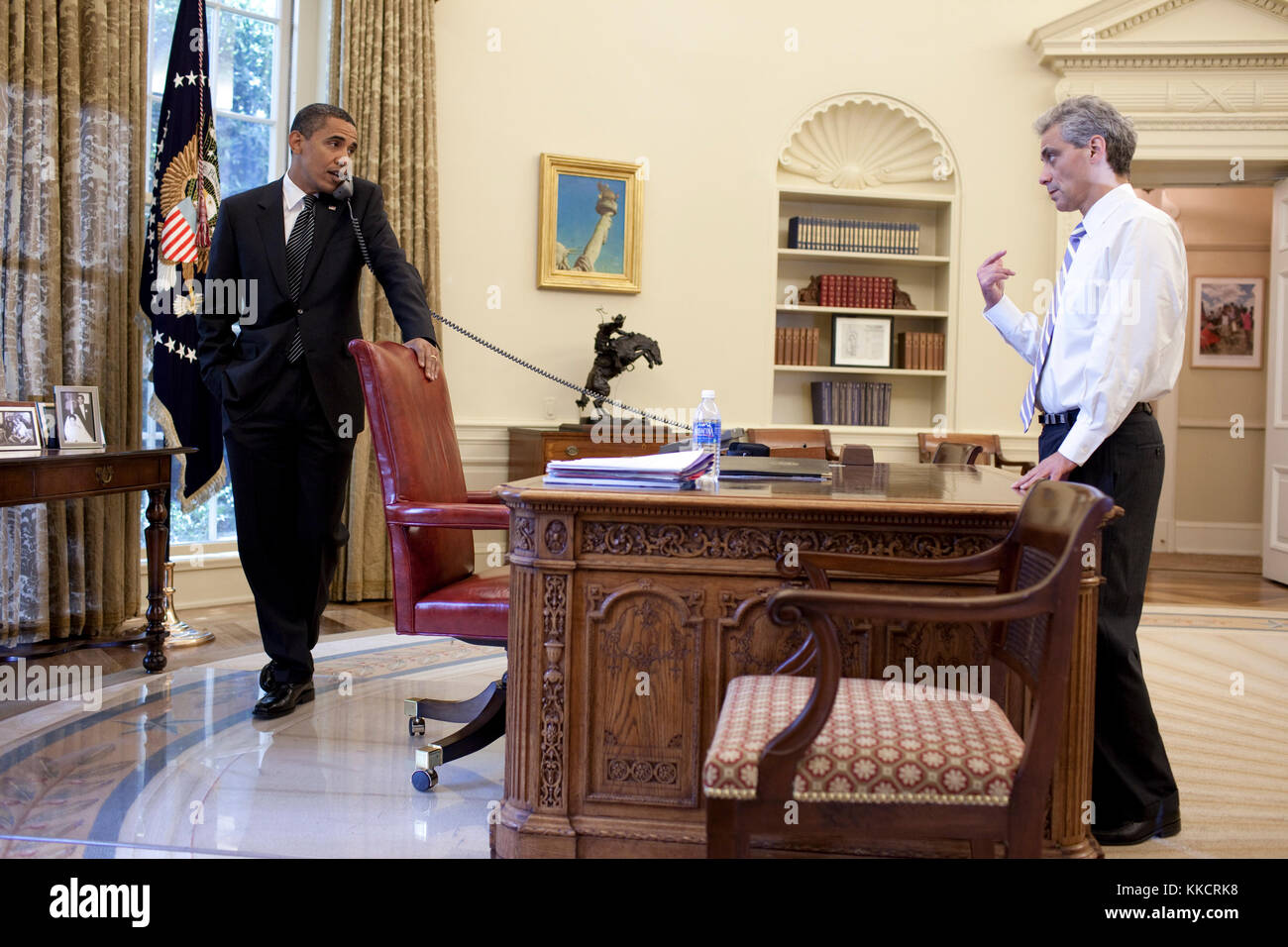 President Barack Obama talks with Chief of Staff Rahm Emanuel during a phone call in the Oval Office, June 25, 2009 Stock Photo
