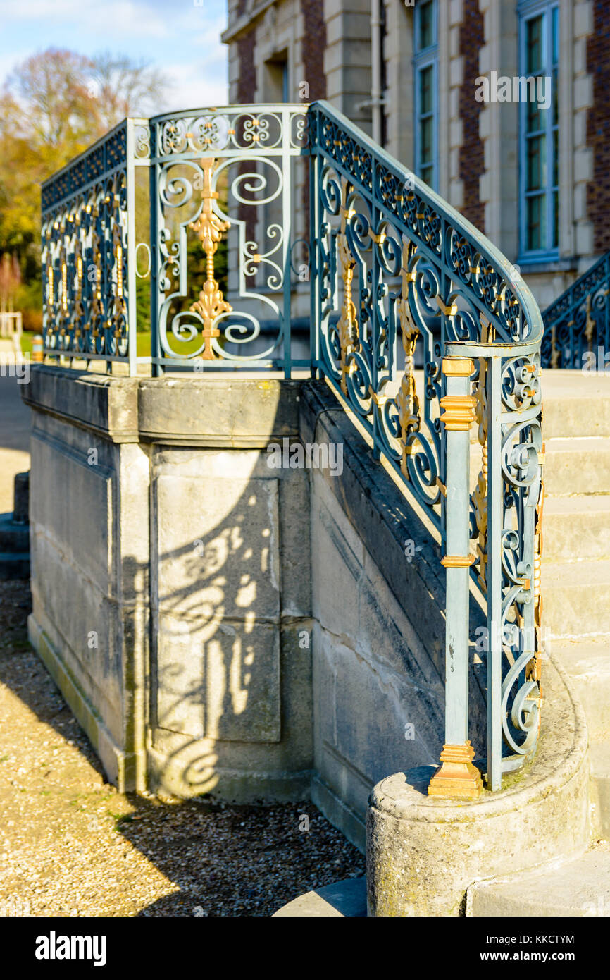 Sceaux, France - November 26, 2017: The wrought iron railing of the garden side staircase of the Sceaux castle by a sunny morning. Stock Photo