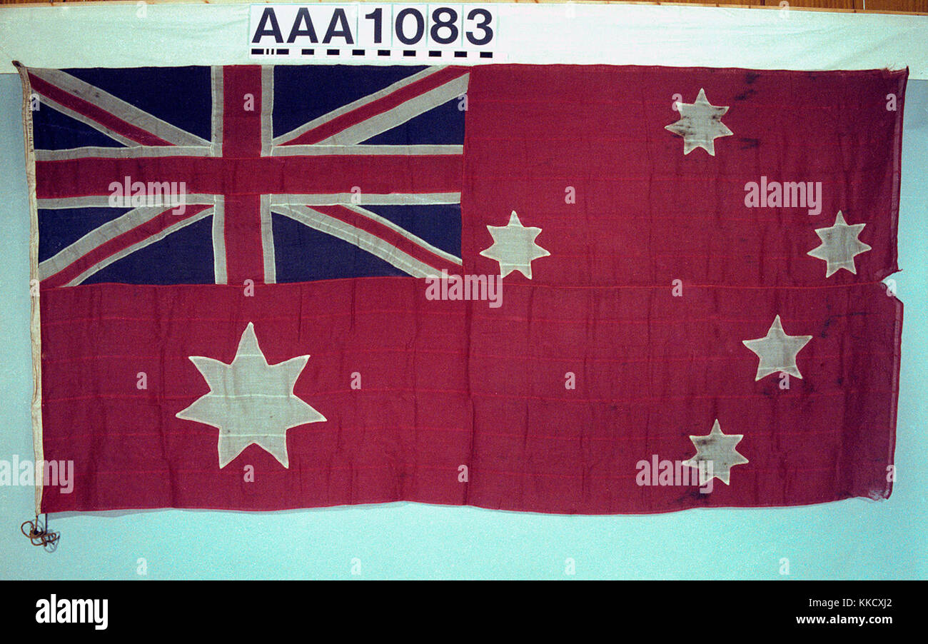 The 1909 pattern Australian ensign, worn  by SS 'Ferndale' 1925. the ensign is made of wool bunting, with a  linen hoist and is  machine sewn. A rope and a  wooden toggle is attached.  The ensign is red with the Union Flag in the canton and the Southern Cross constellation of five white stars in the fly. On the lower left side, a large white star with seven points. Inscribed on hoist: 'YD RED ENSIGN AUSTRALIAN'.  The last flag to be flown by the Australian Commonwealth Line prior to their transfer to the Aberdeen White Star Line in 1928.  AAA1083 Australian merchant ensign (after 1909) RMG RP- Stock Photo