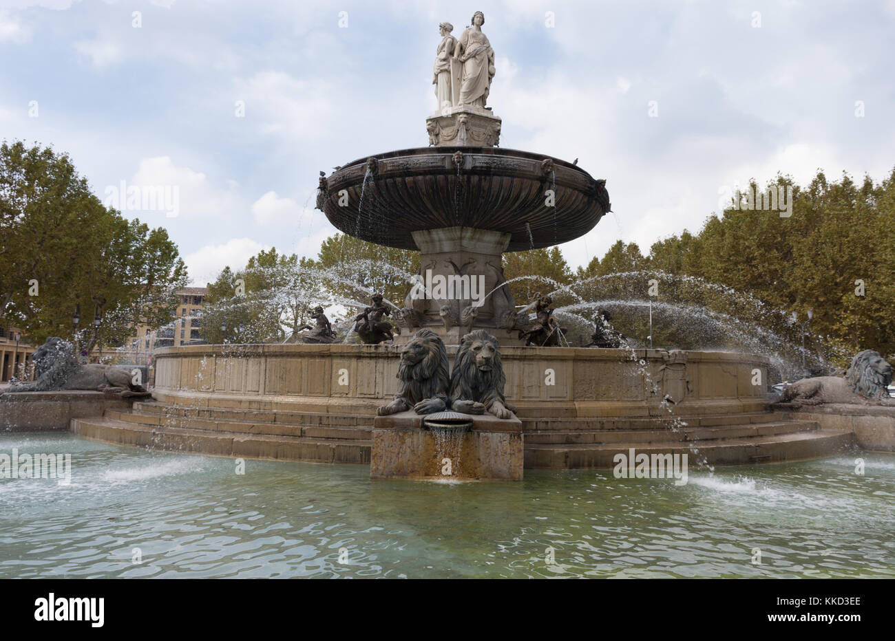 The Fountaine de la Rotonde in Aix in Provence, France. The statues of women represent Fine Arts, Agriculture and Justice. Trees are in the background Stock Photo