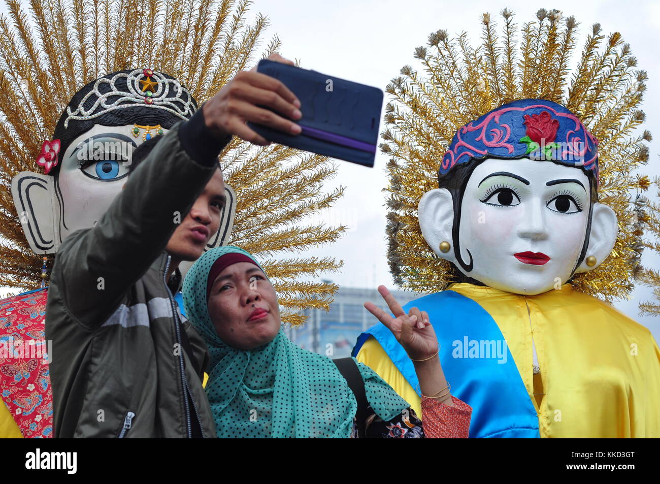 Jakarta, Indonesia - November 26, 2017: Monas visitor take picture with Ondel-ondel  the tradition puppet from Jakarta, Indonesia Stock Photo