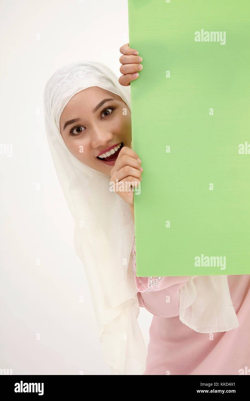 malay woman with tudung,behind of the green placard Stock Photo Alamy
