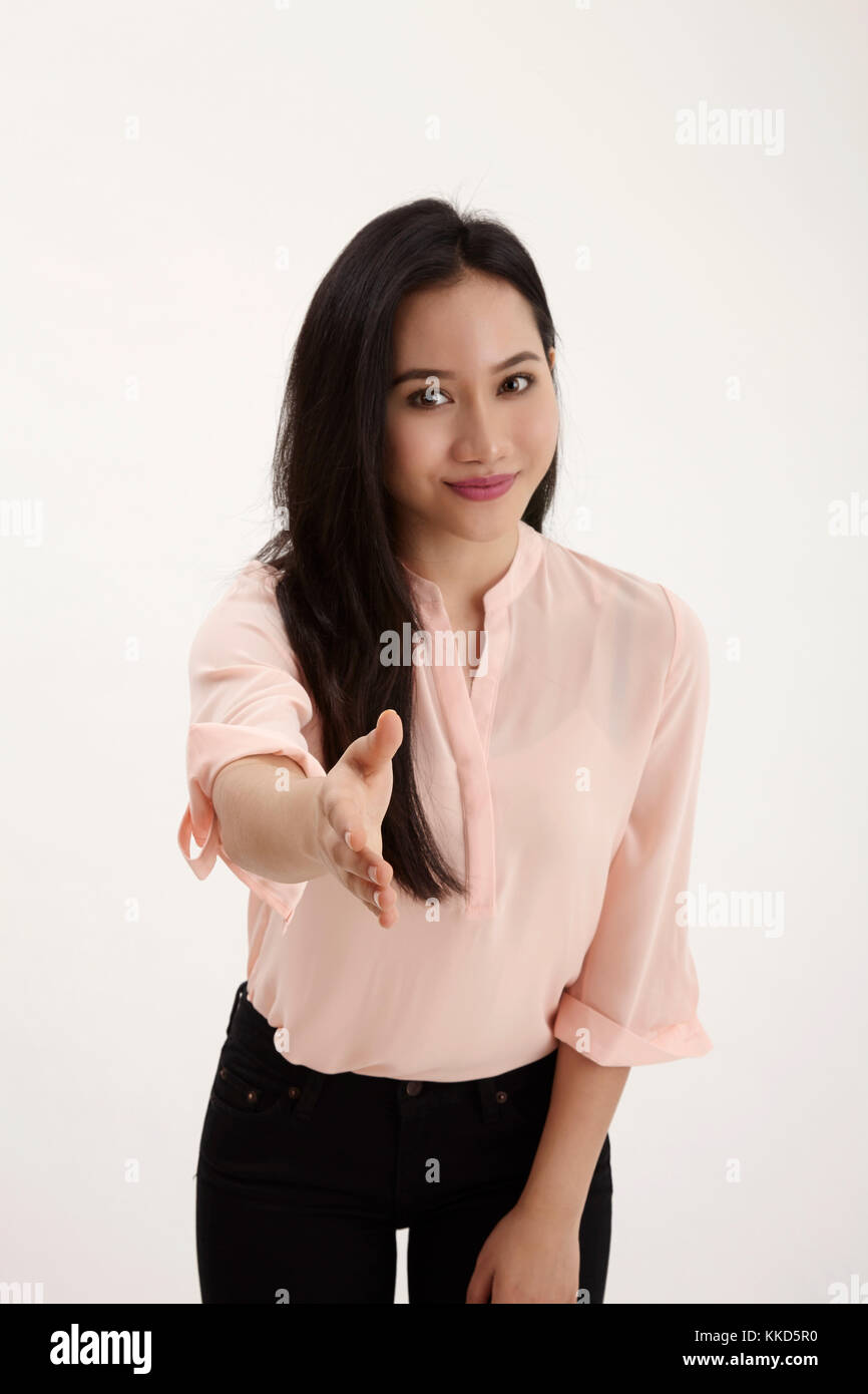 malay woman raising arm about to do hand shake Stock Photo Alamy