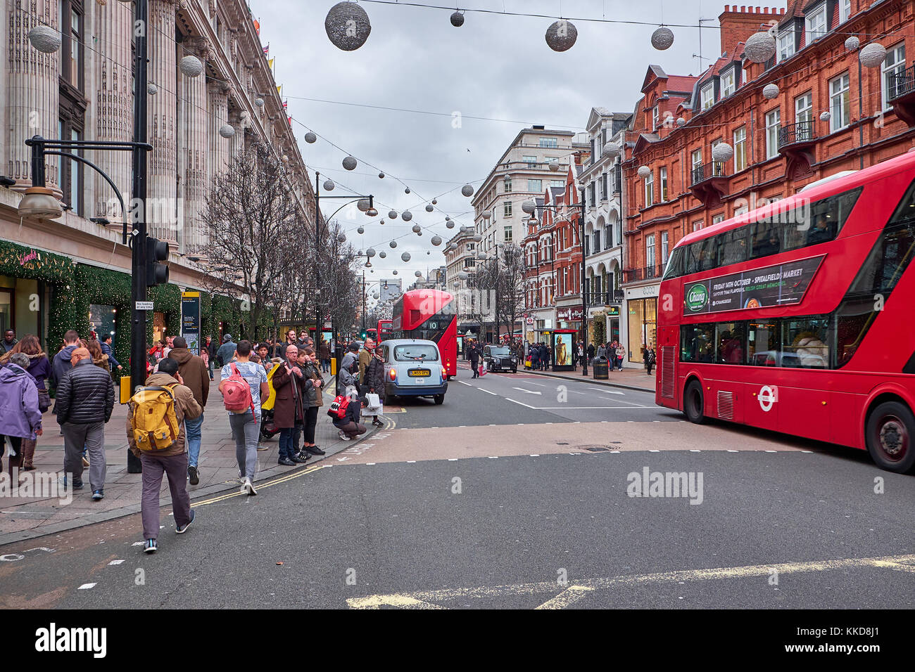 LONDON CITY - DECEMBER 23, 2016: Street crowded with red double decker buses, and many people, in Oxford Street at Christmas time Stock Photo