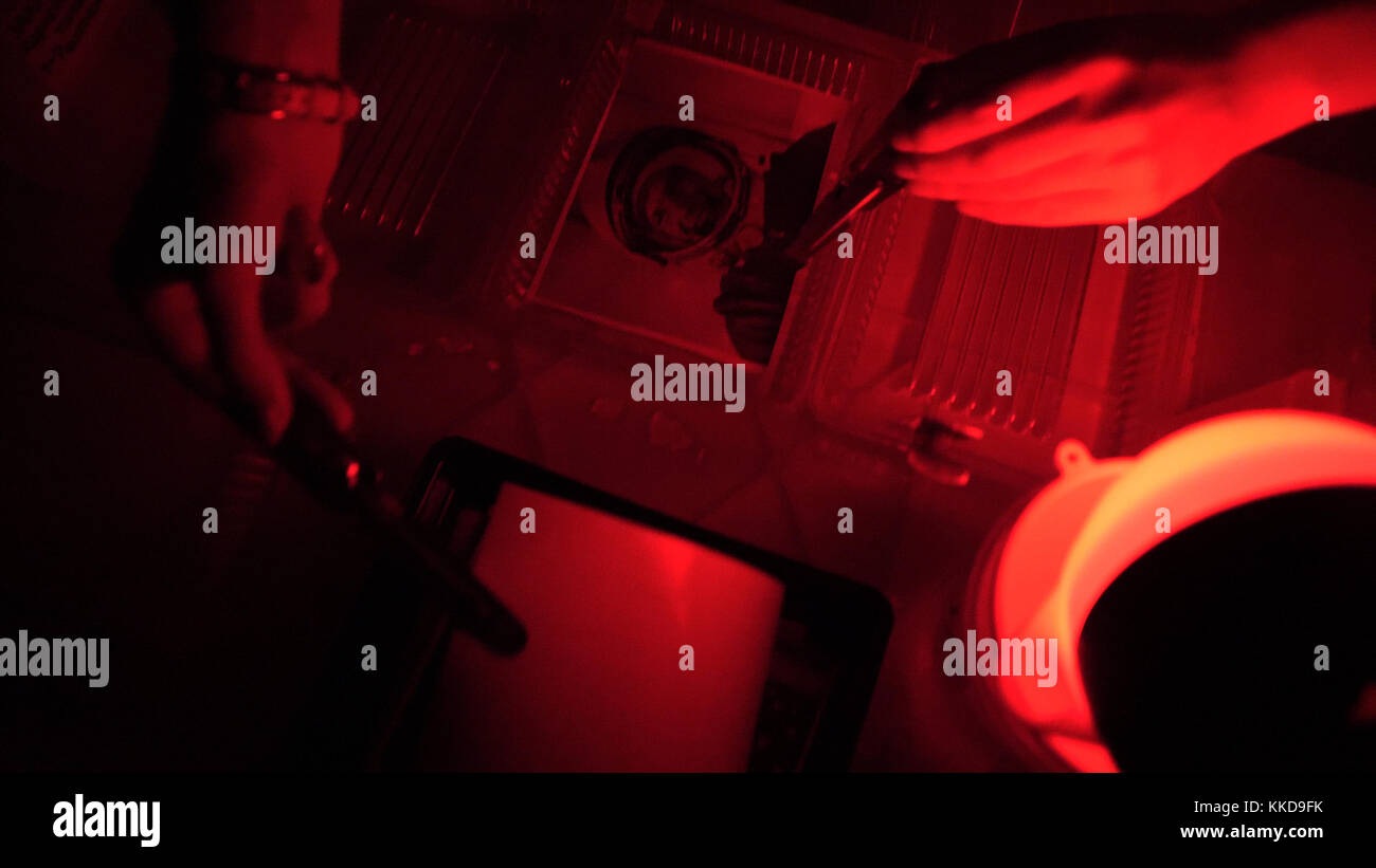 Darkroom printing process photographer using enlarger to produce