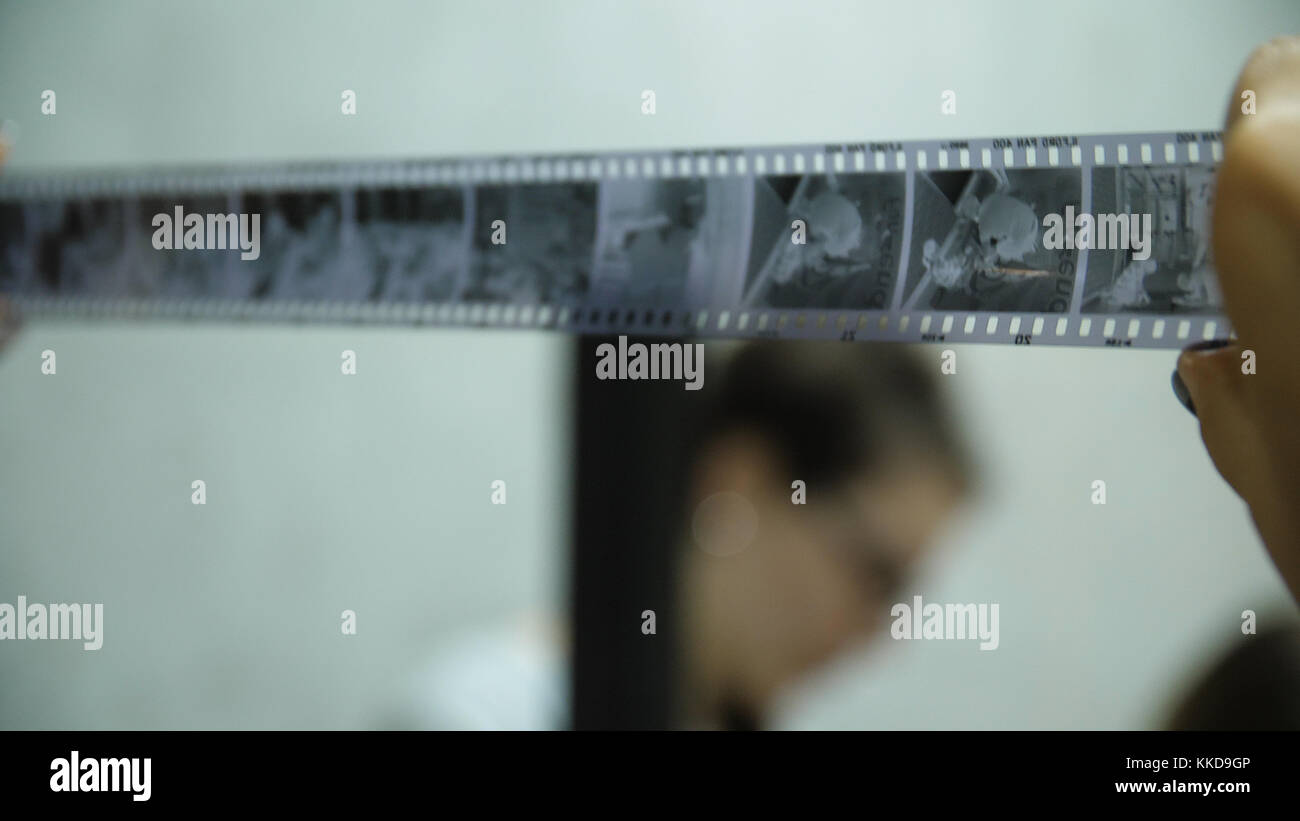 Photographer looking on negative film. Done work inspecting. Old