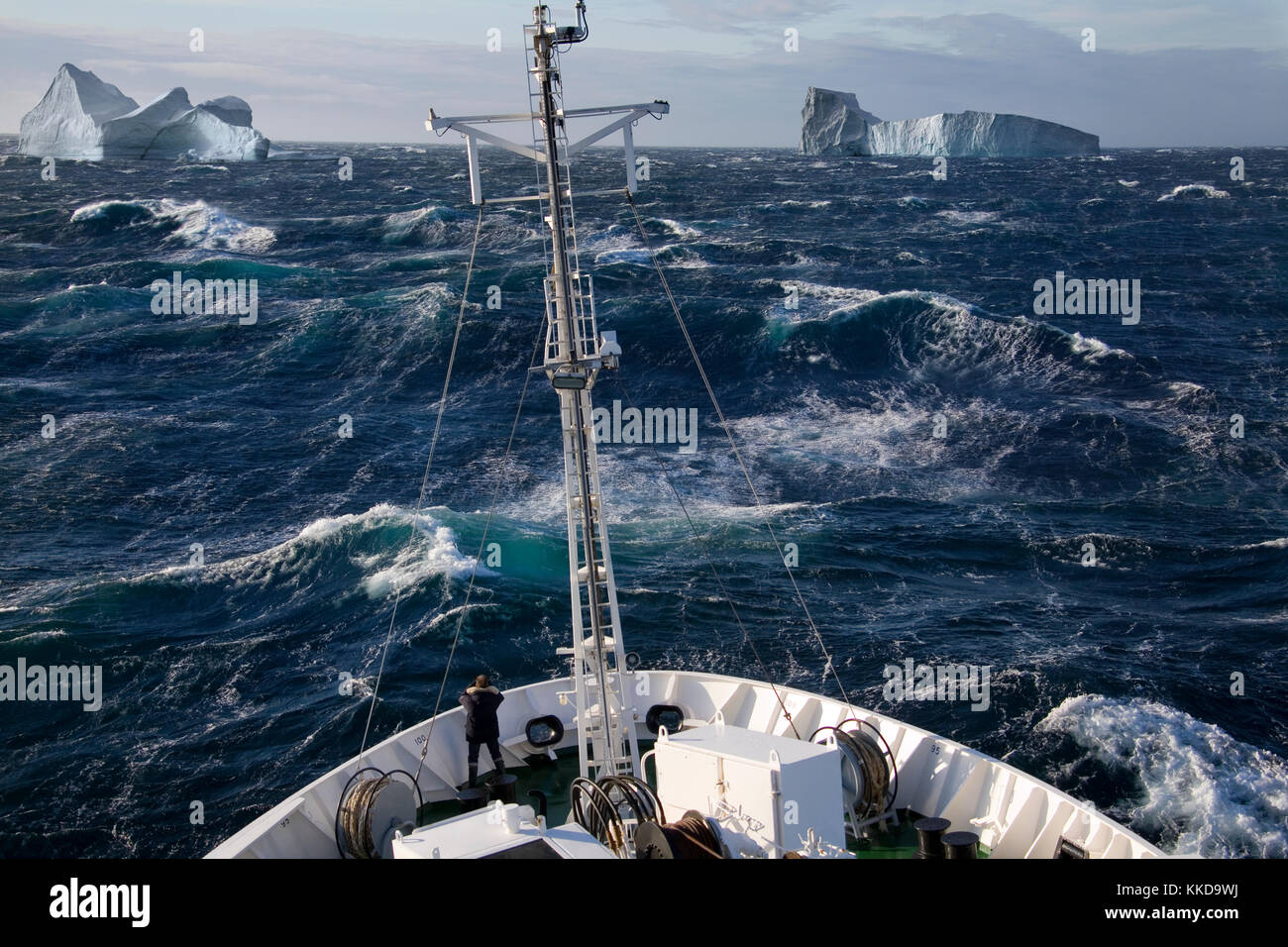 A ship rolling in heavy seas near iceburgs in Scoresbysund on the east coast of Greenland. Stock Photo