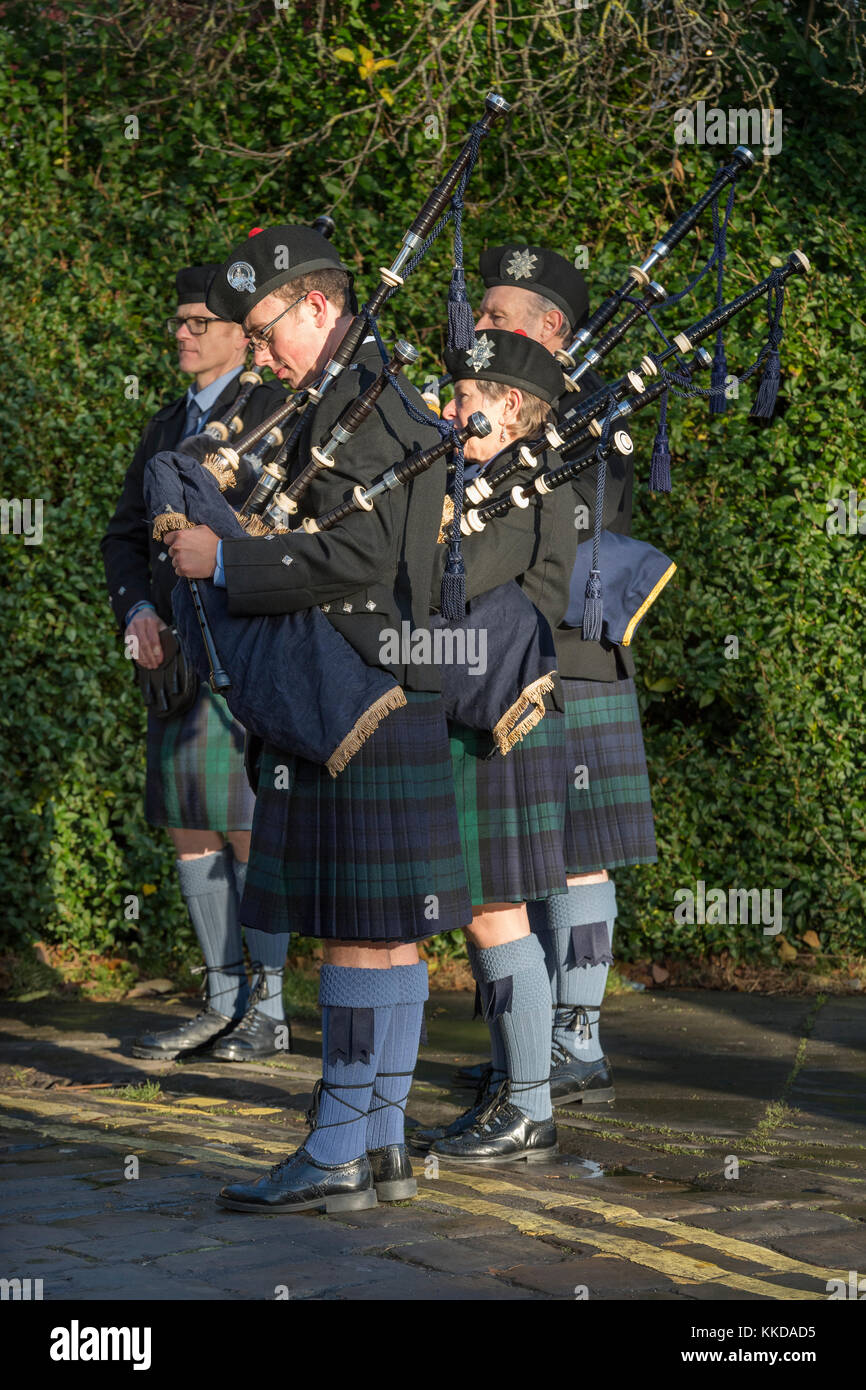 Members of pipe band with pipes, chat before parade by York Minster on 50th anniversary of British withdrawal from Aden - Yorkshire, England, GB, UK. Stock Photo