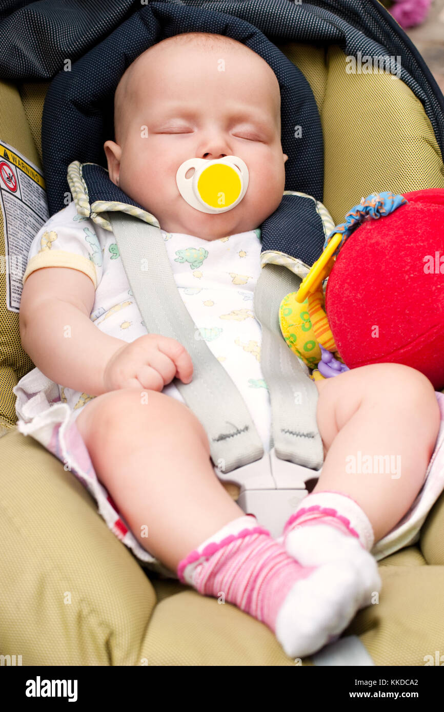 Four month infant sleeping in a car seat Stock Photo Alamy