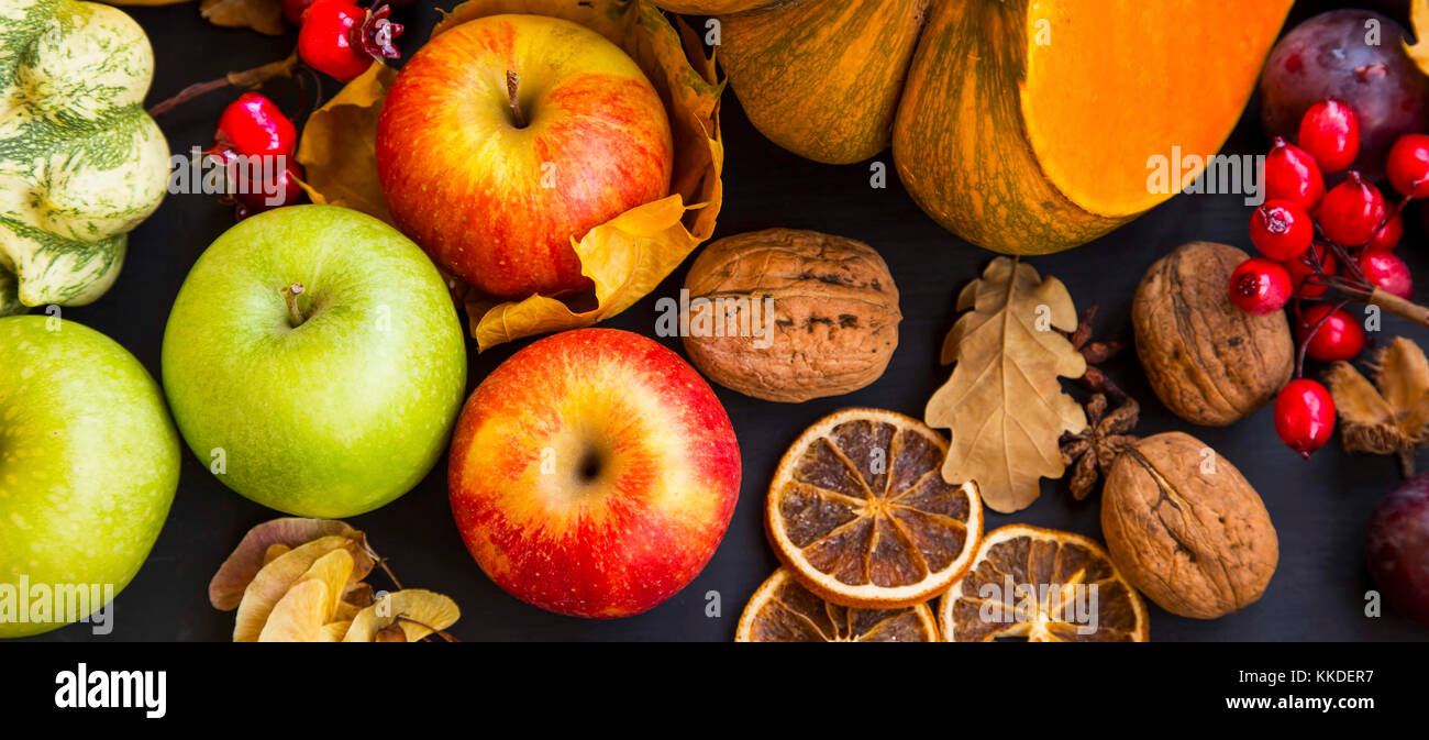 Autumn harvest with apples, pumpkins, squash, nuts,plums and chestnuts , top view Stock Photo