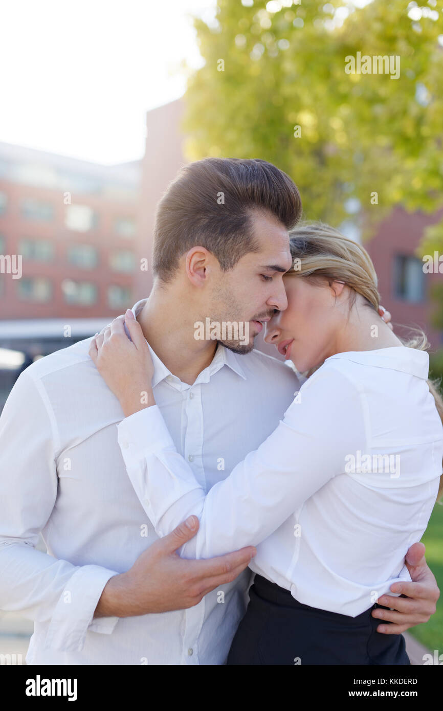 Young caucasian couple embrace each other at morning in city, love Stock Photo
