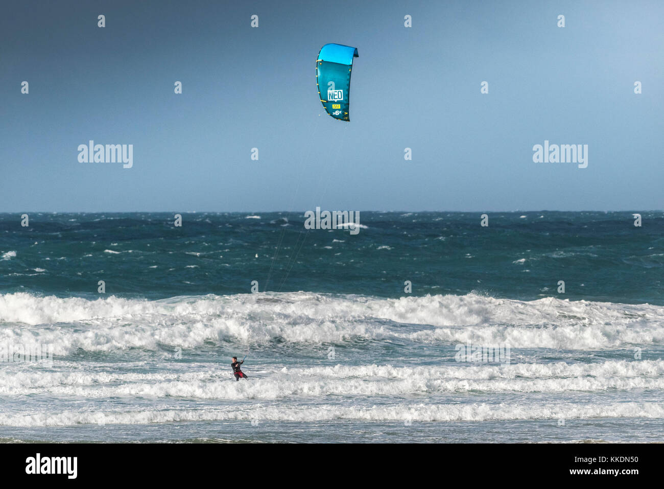Para-surfing - a kite-surfer para-surfer kite surfing in rough seas at Fistral in Newquay Cornwall UK. Stock Photo