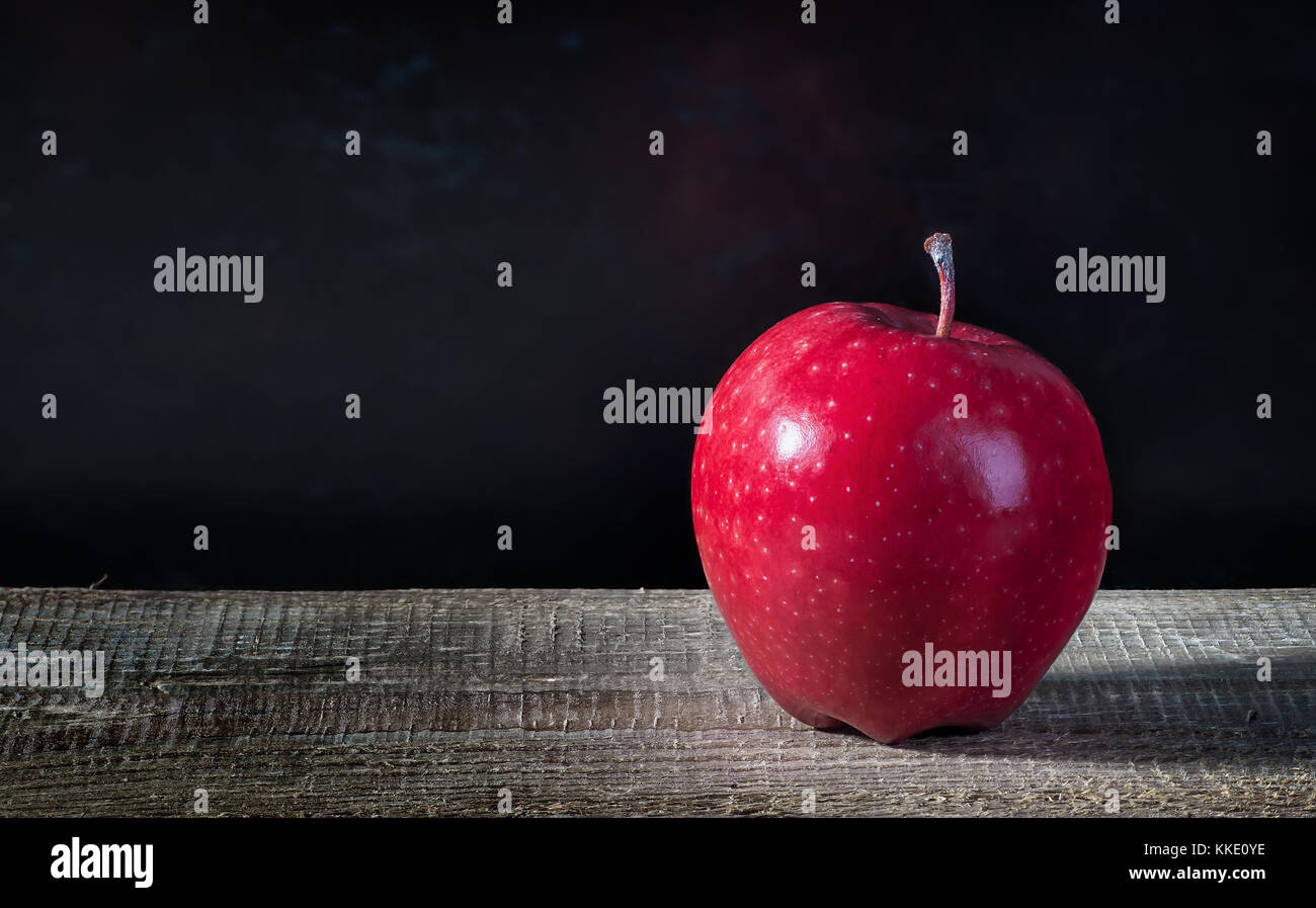Single apple on a wooden table Stock Photo
