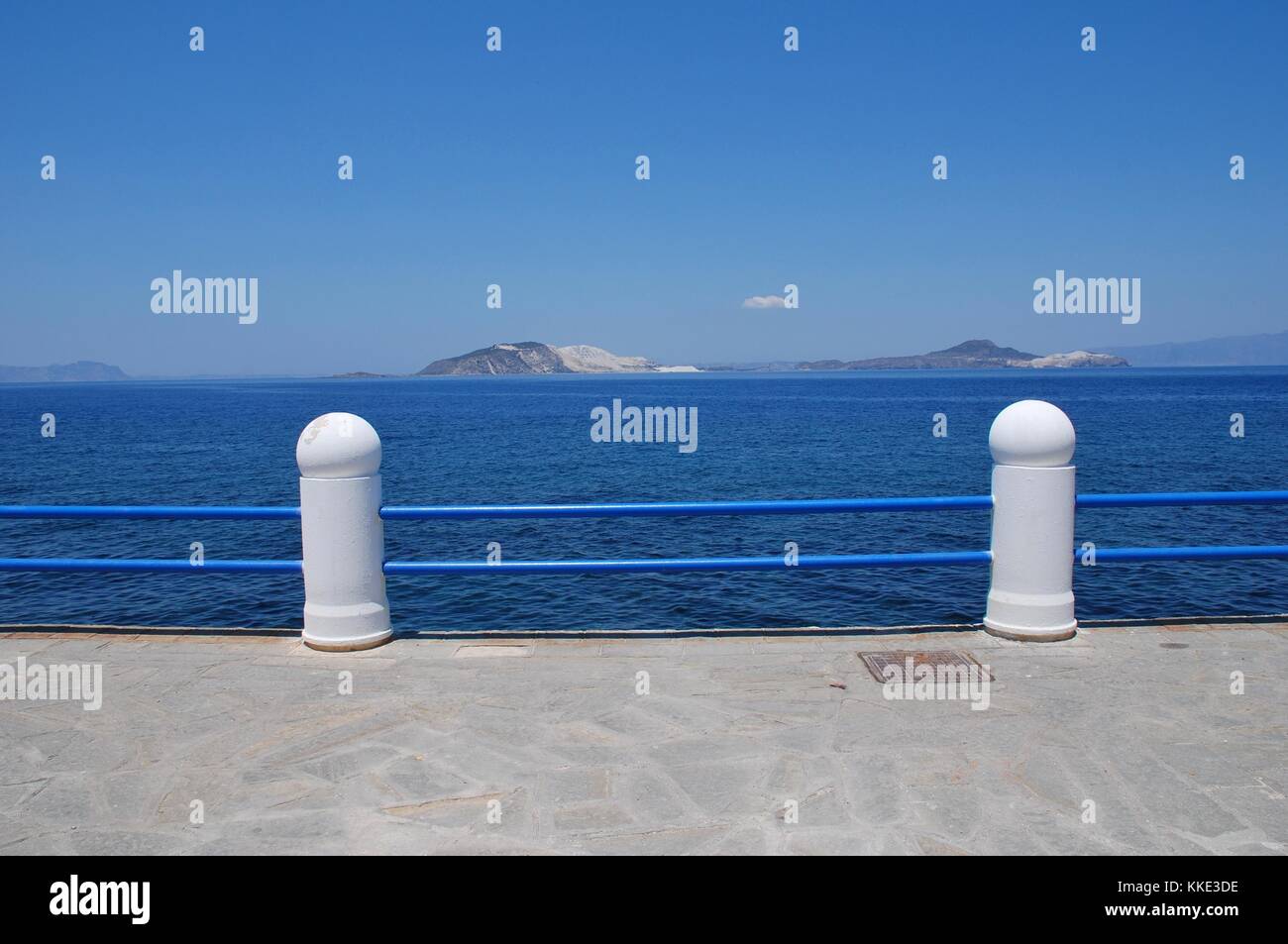 Railings on the seafront at Mandraki on the Greek island of Nisyros. Stock Photo