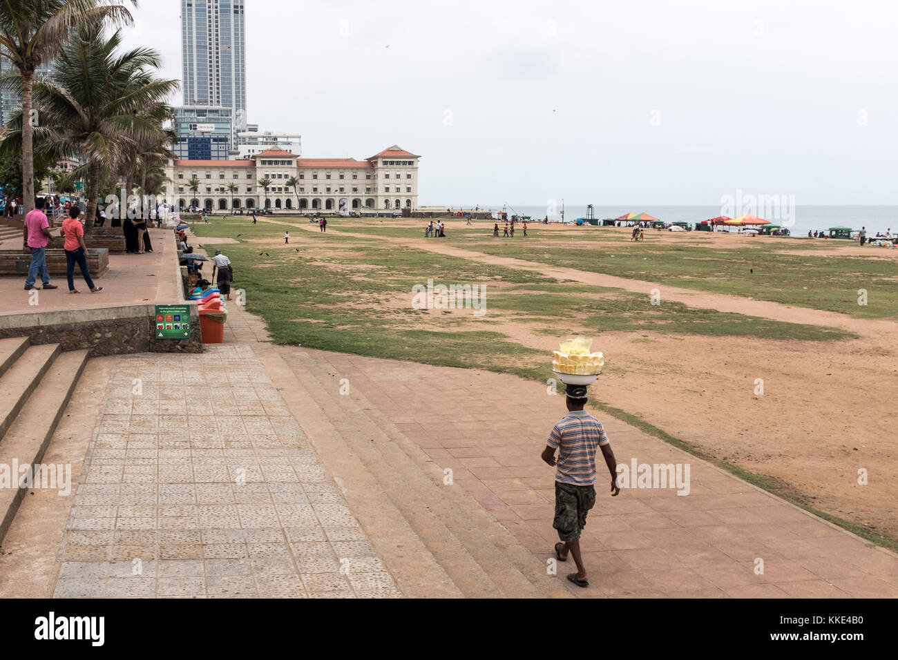 A vendor carries his goods on his head at Galle Face Green in Colombo, Sri Lanka. Stock Photo