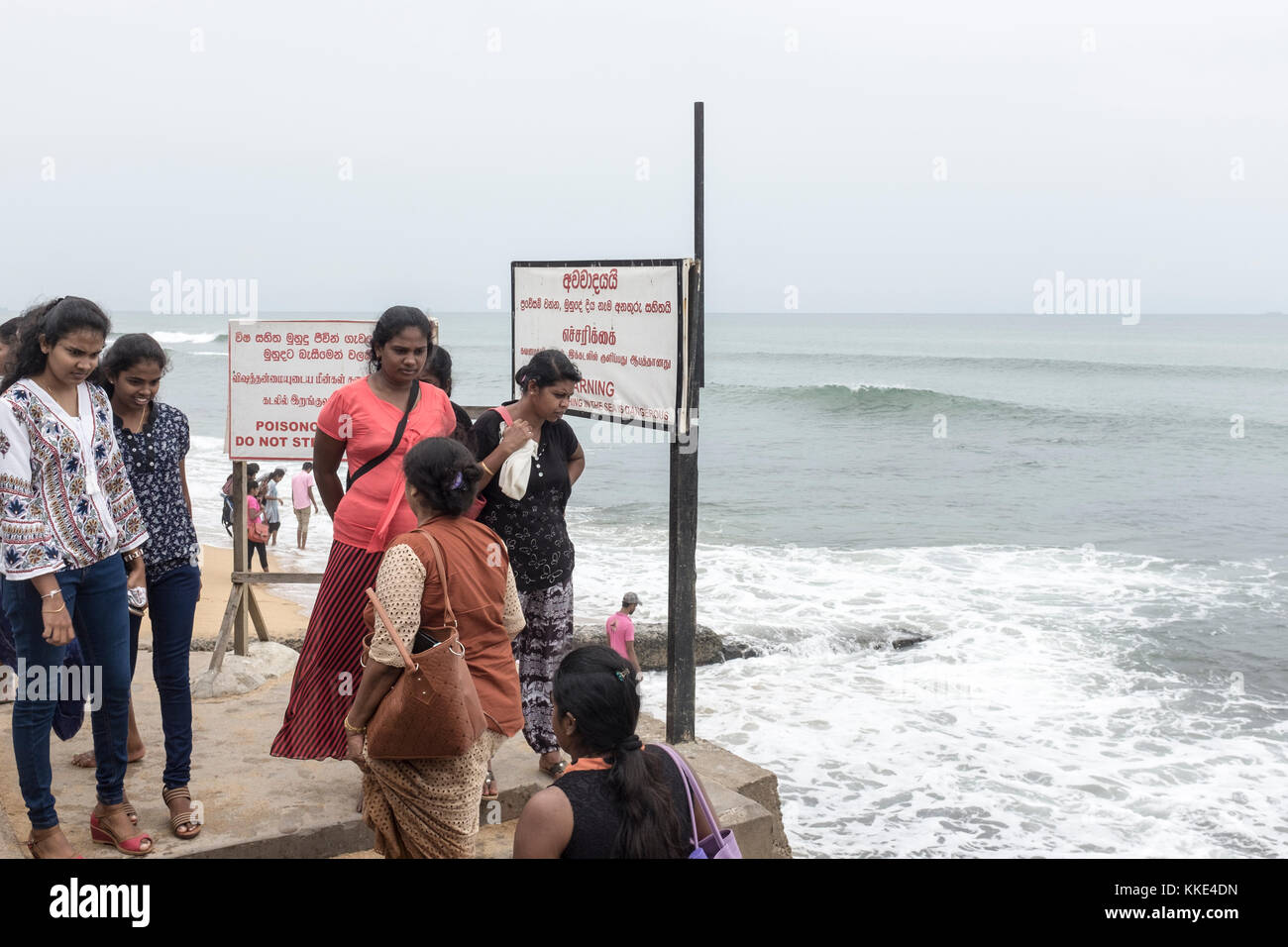 Women look at the sea at Galle Face Green in Colombo, Sri Lanka. Stock Photo