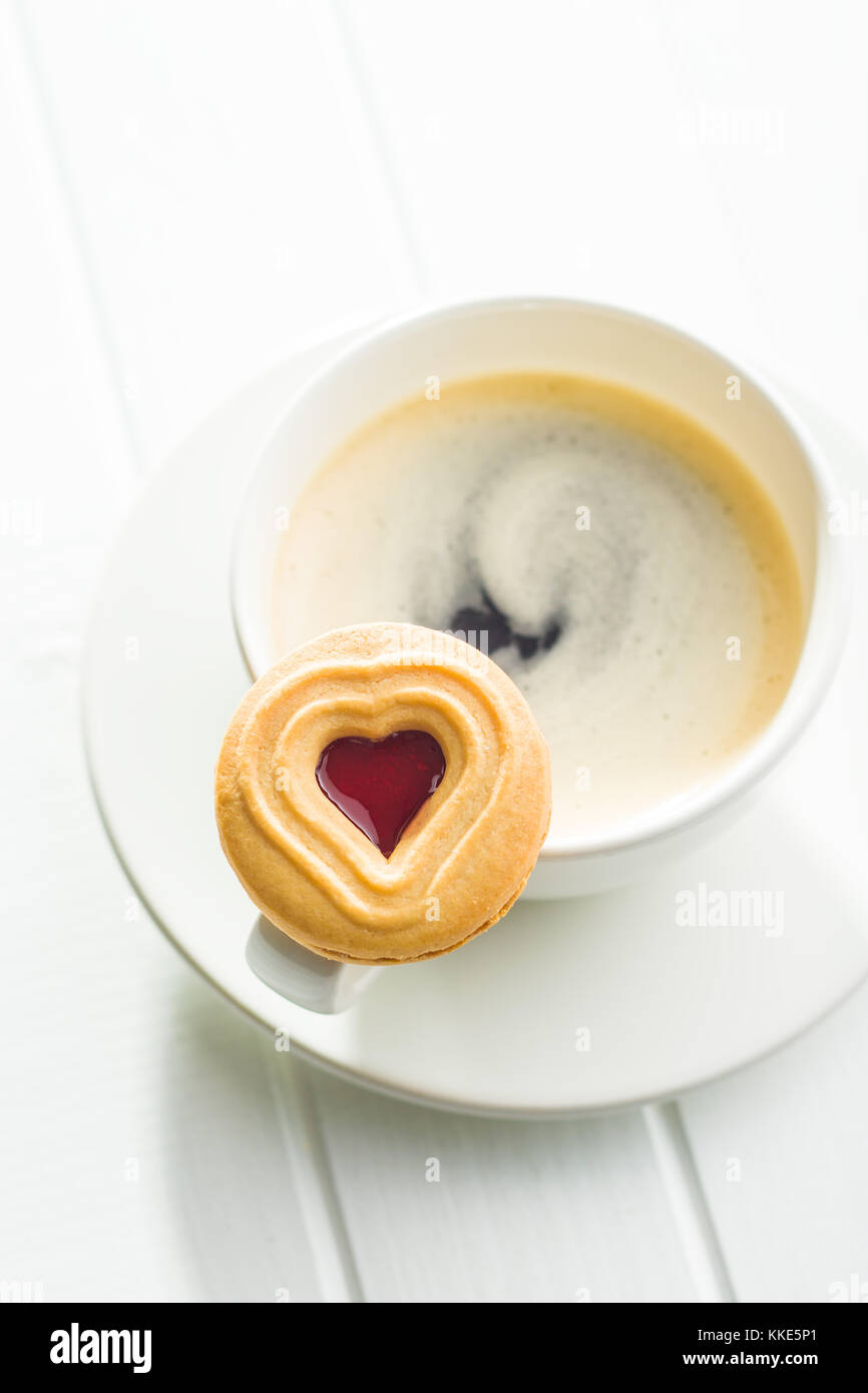 Sweet jelly cookies and coffee cup on table. Stock Photo