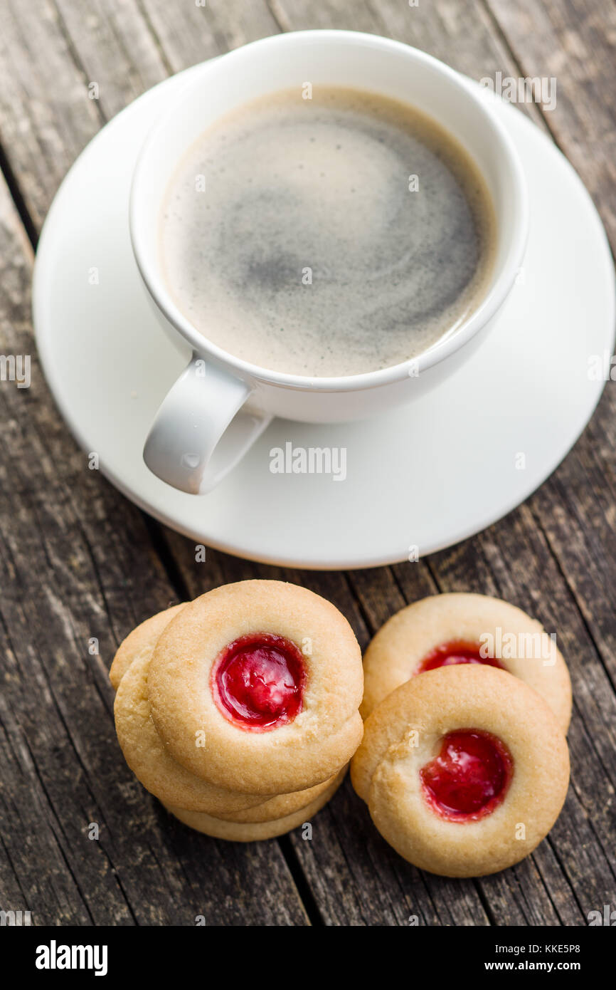 Sweet jelly cookies and coffee cup on table. Stock Photo