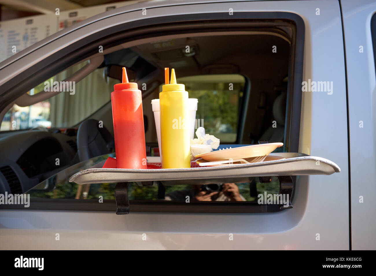 Portable car table with condiments at a takeaway or roadside restaurant